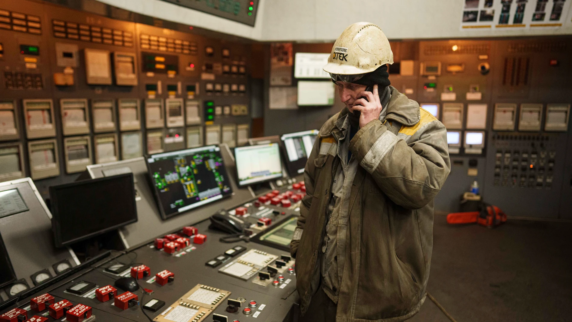 A worker speaks by mobile phone inside operating room at DTEK's power plant after a recent Russian missile attack in Ukraine, Nov. 28, 2024. (AP Photo/Evgeniy Maloletka)