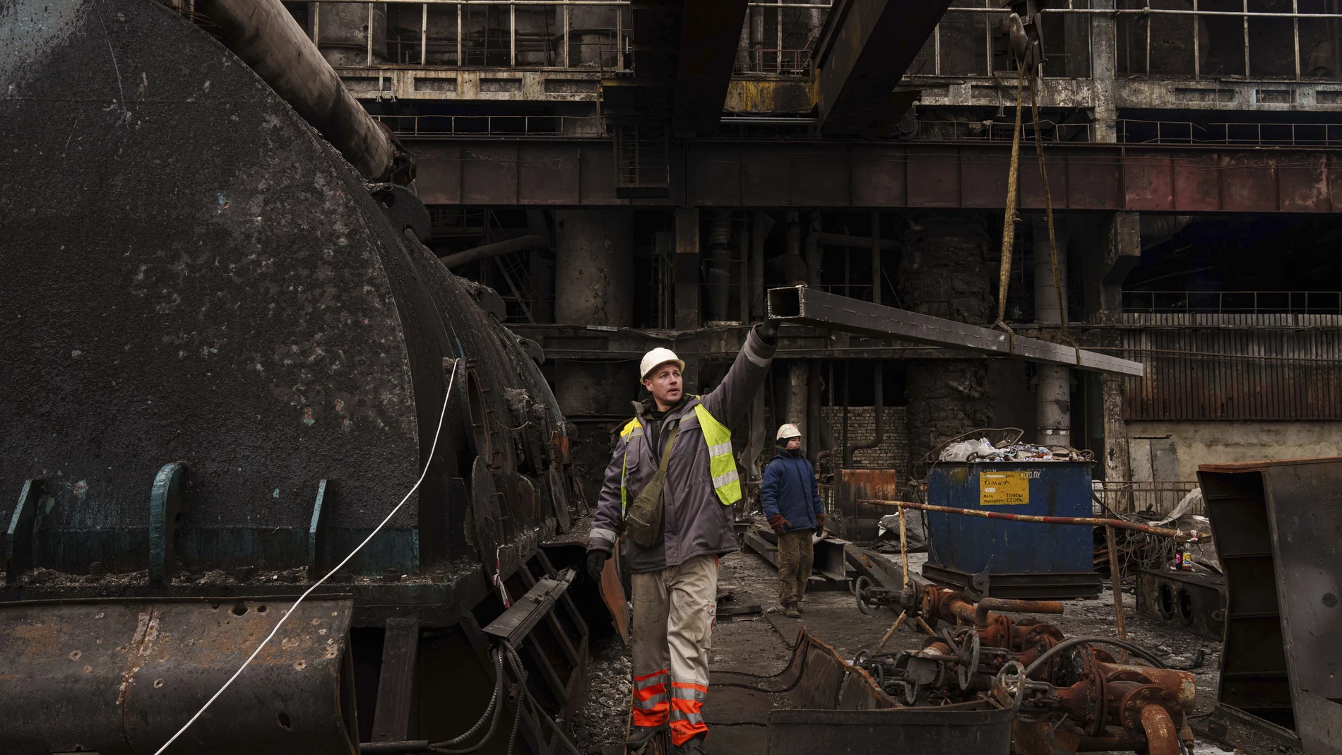 A worker lowers a metal bar to the ground using a crane during repairs to DTEK's power plant after a recent Russian missile attack in Ukraine, Nov. 28, 2024.