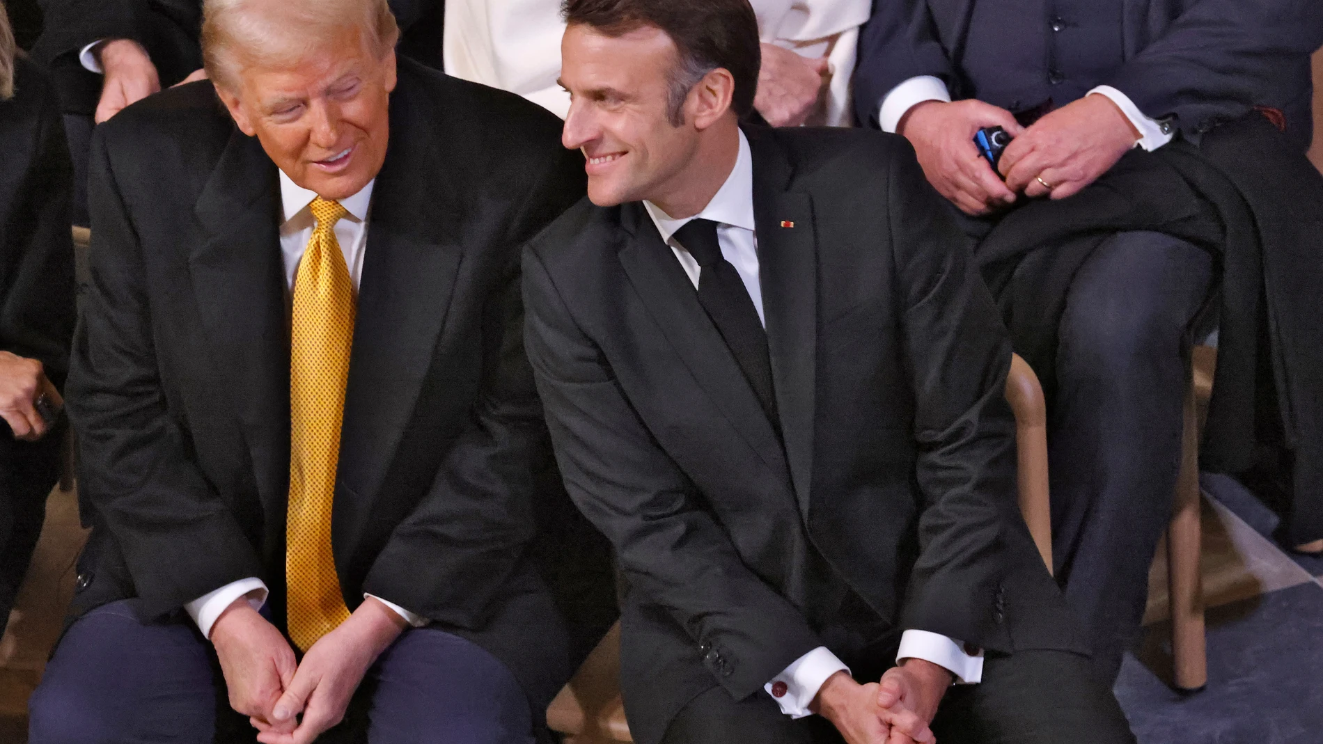 US President-elect Donald Trump talks with French President Emmanuel Macron in Notre Dame Cathedral as France's iconic cathedral is formally reopening its doors for the first time since a devastating fire nearly destroyed the 861-year-old landmark in 2019, Saturday Dec.7, 2024 in Paris. ( Ludovic Marin, Pool via AP)