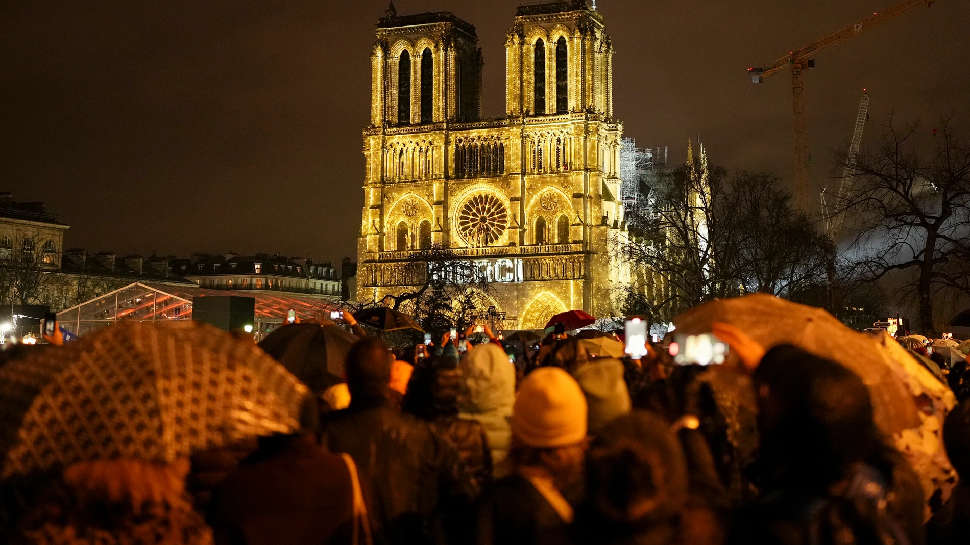 Spectators gather outside France's iconic Notre Dame Cathedral Saturday, Dec. 7, 2024 in Paris for it's formal reopening for the first time since a devastating fire nearly destroyed the 861-year-old landmark in 2019. (AP Photo/Alessandra Tarantino)