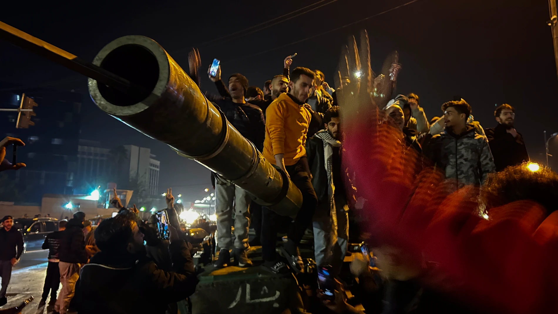Syrians celebrate the arrival of opposition fighters in Damascus, Syria, Sunday Dec. 8, 2024. (AP Photo/Omar Sanadiki)