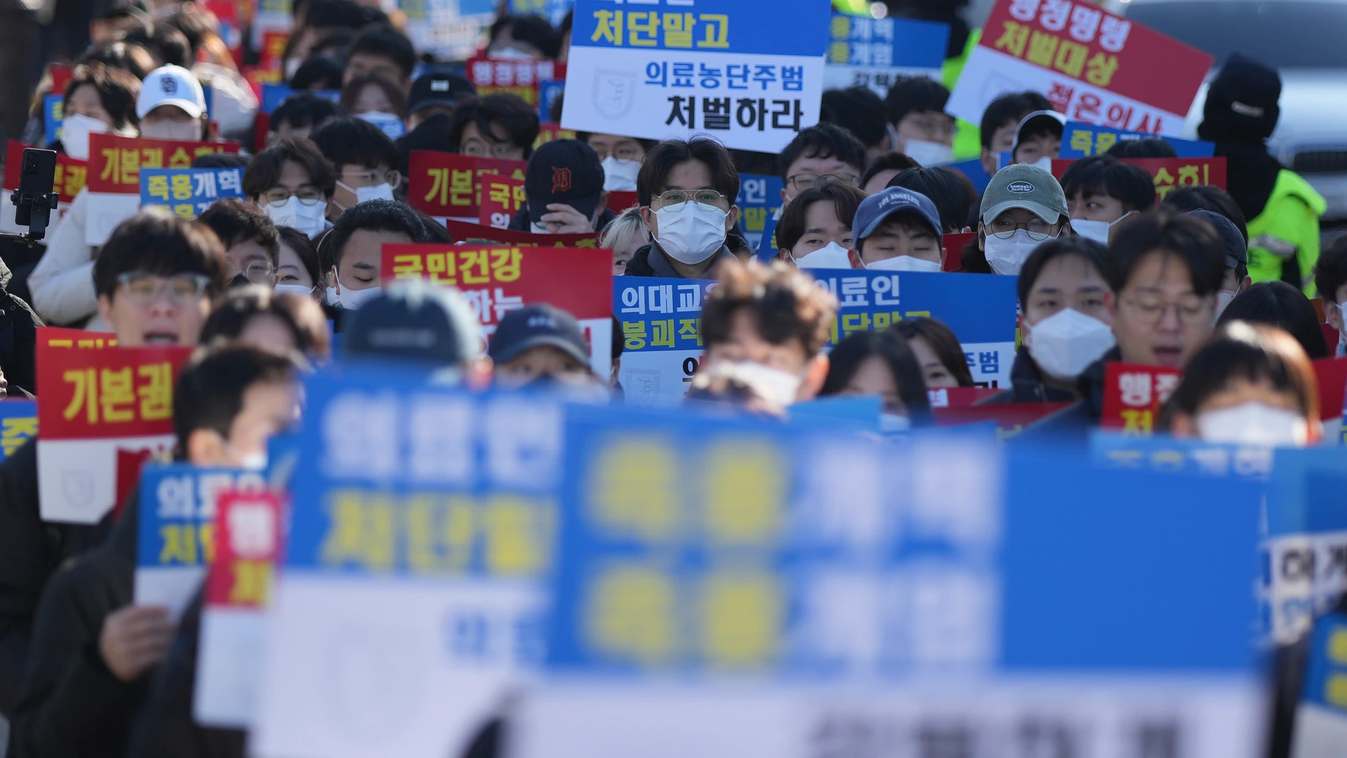 Trainee doctors and medical students attend at a rally to denounce South Korean President Yoon Suk Yeol and against the government's medical reform in Seoul, South Korea, Sunday, Dec. 8, 2024. The signs read "Executive order and Subject to punishment." (AP Photo/Lee Jin-man)