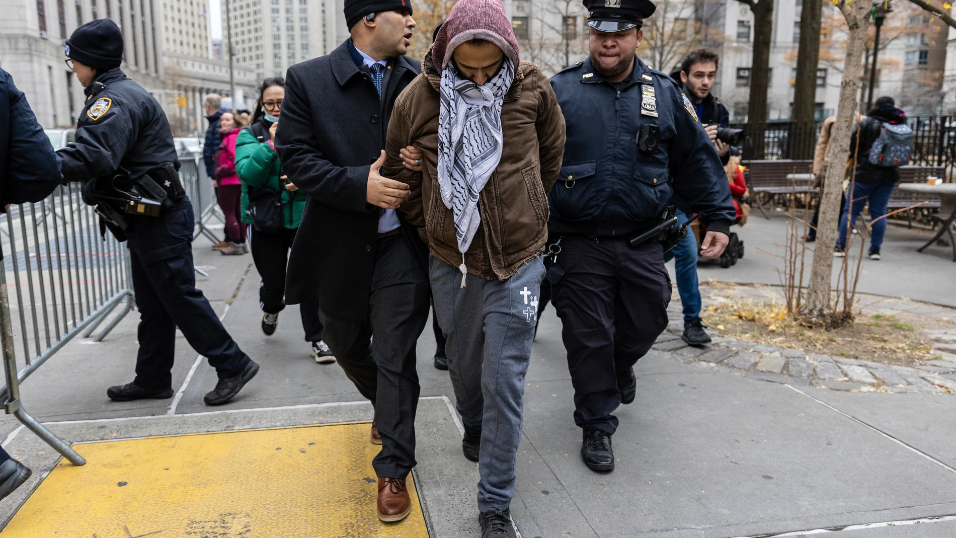 A person protesting the not guilty verdict of Daniel Penny is arrested by police outside the criminal court, Monday, Dec. 9, 2024, in New York. (AP Photo/Stefan Jeremiah)