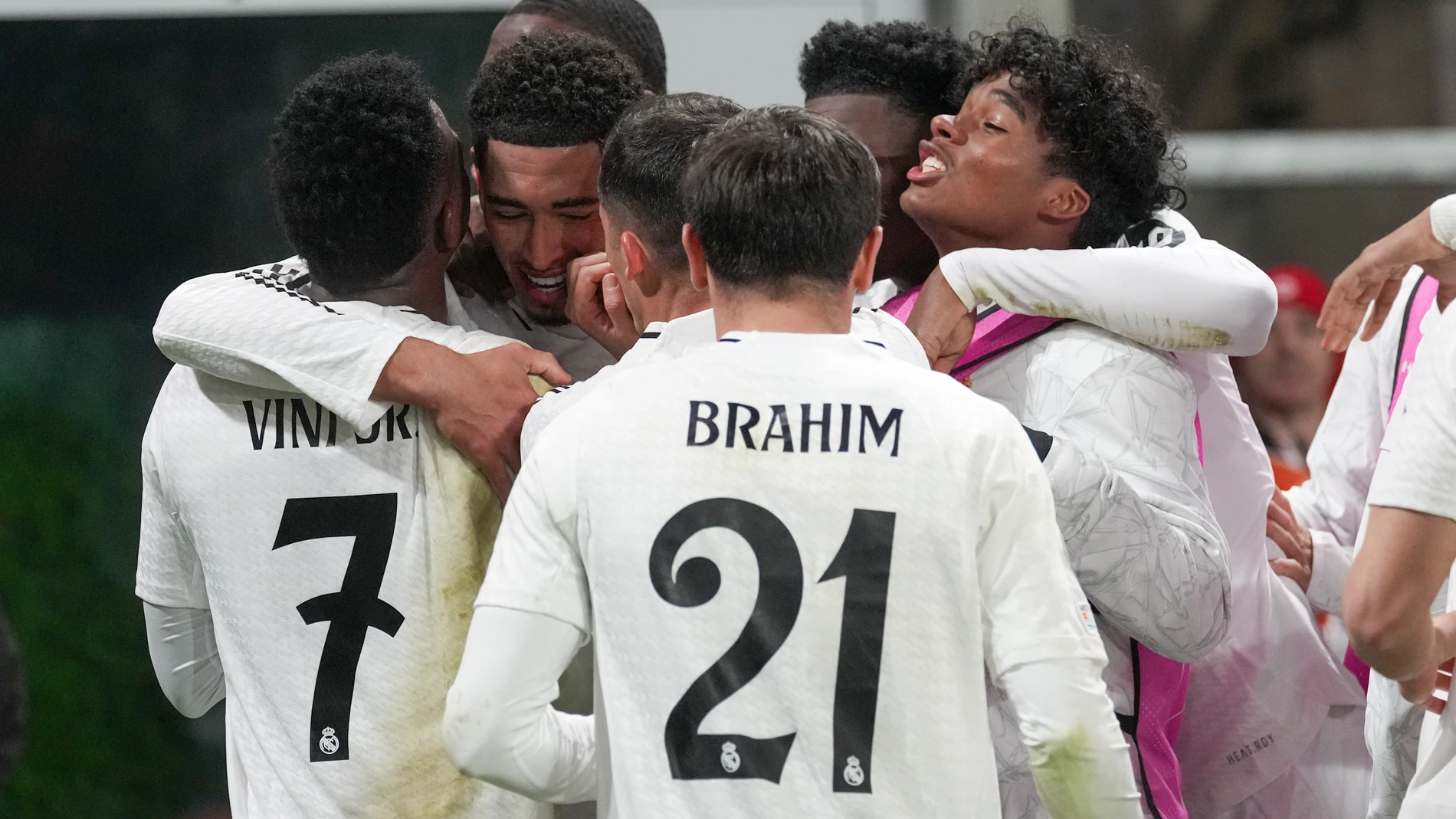 Real Madrid's Jude Bellingham, second from left, celebrates with his teammates after he scored his side's third goal during the Champions League opening phase soccer match between Atalanta and Real Madrid at the Bergamo's stadium, in Bergamo, Italy, Tuesday, Dec. 10, 2024. (AP Photo/Antonio Calanni)