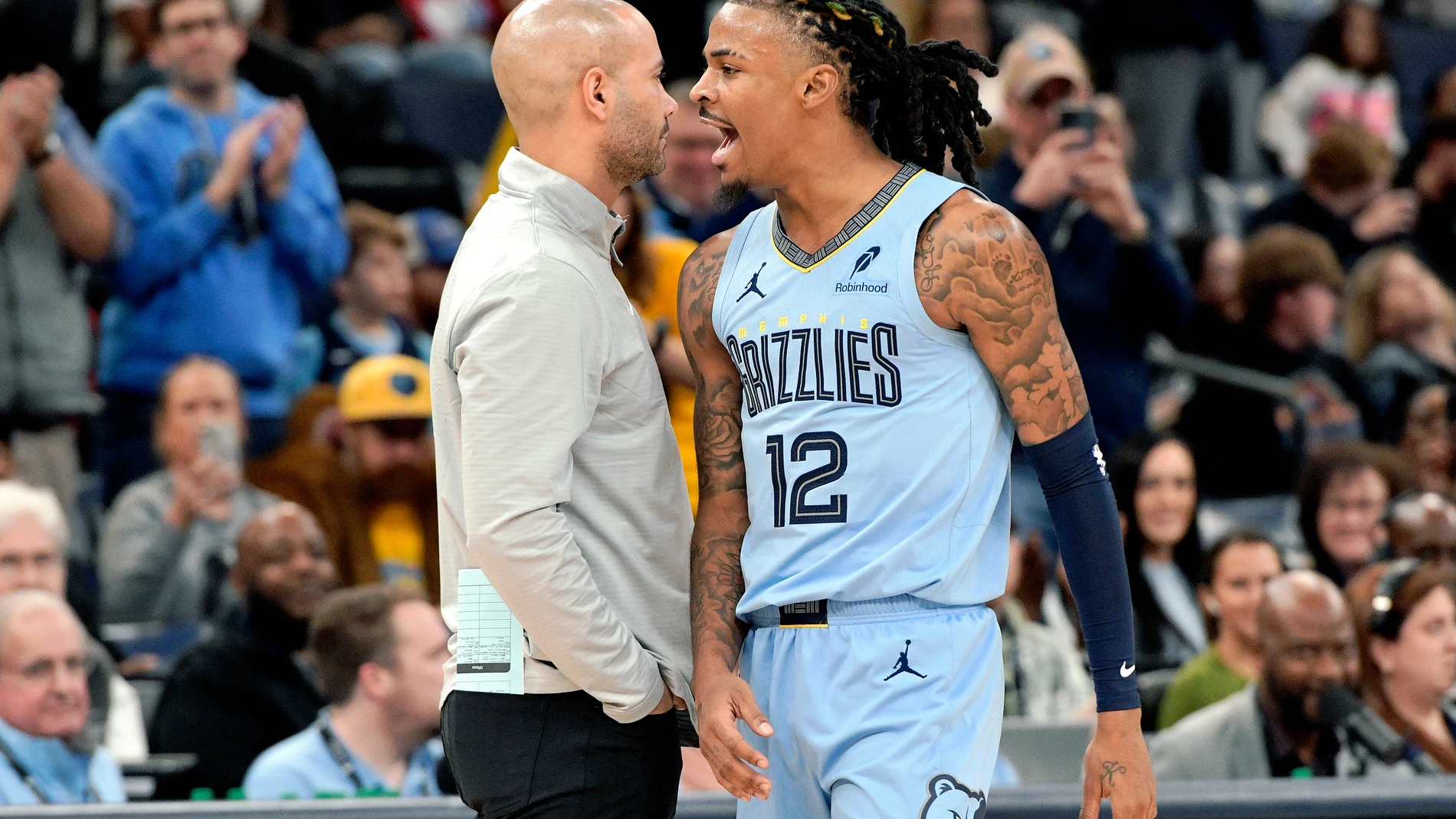 Memphis Grizzlies guard Ja Morant (12) reacts beside Brooklyn Nets head coach Jordi Fernandez, left, in the first half of an NBA basketball game Friday, Dec. 13, 2024, in Memphis, Tenn. (AP Photo/Brandon Dill)