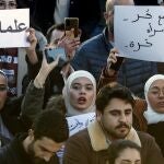 Syrian women chant slogans as they hold placards with Arabic that read: "No for free society without a free woman," right, and "Secularism," left, during a protest to demand a secular state, at the Umayyad square in Damascus, Syria, Thursday, Dec. 19, 2024. 