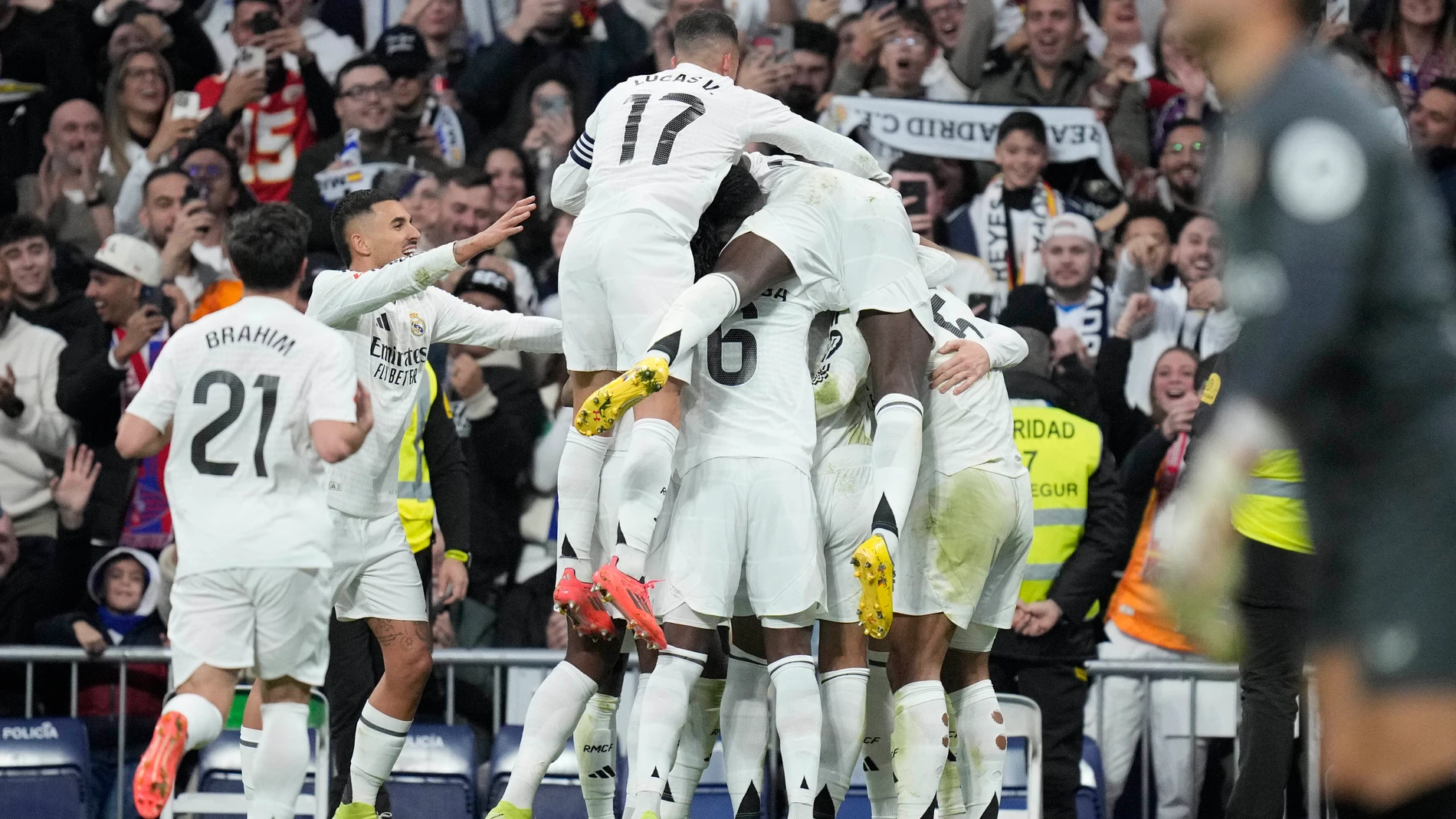 Real Madrid's Federico Valverde celebrates with his teammates after scoring his side's second goal during the Spanish La Liga soccer match between Real Madrid and Sevilla at the Santiago Bernabeu Stadium in Madrid, Spain, Sunday, Dec. 22, 2024. (AP Photo/Bernat Armangue)