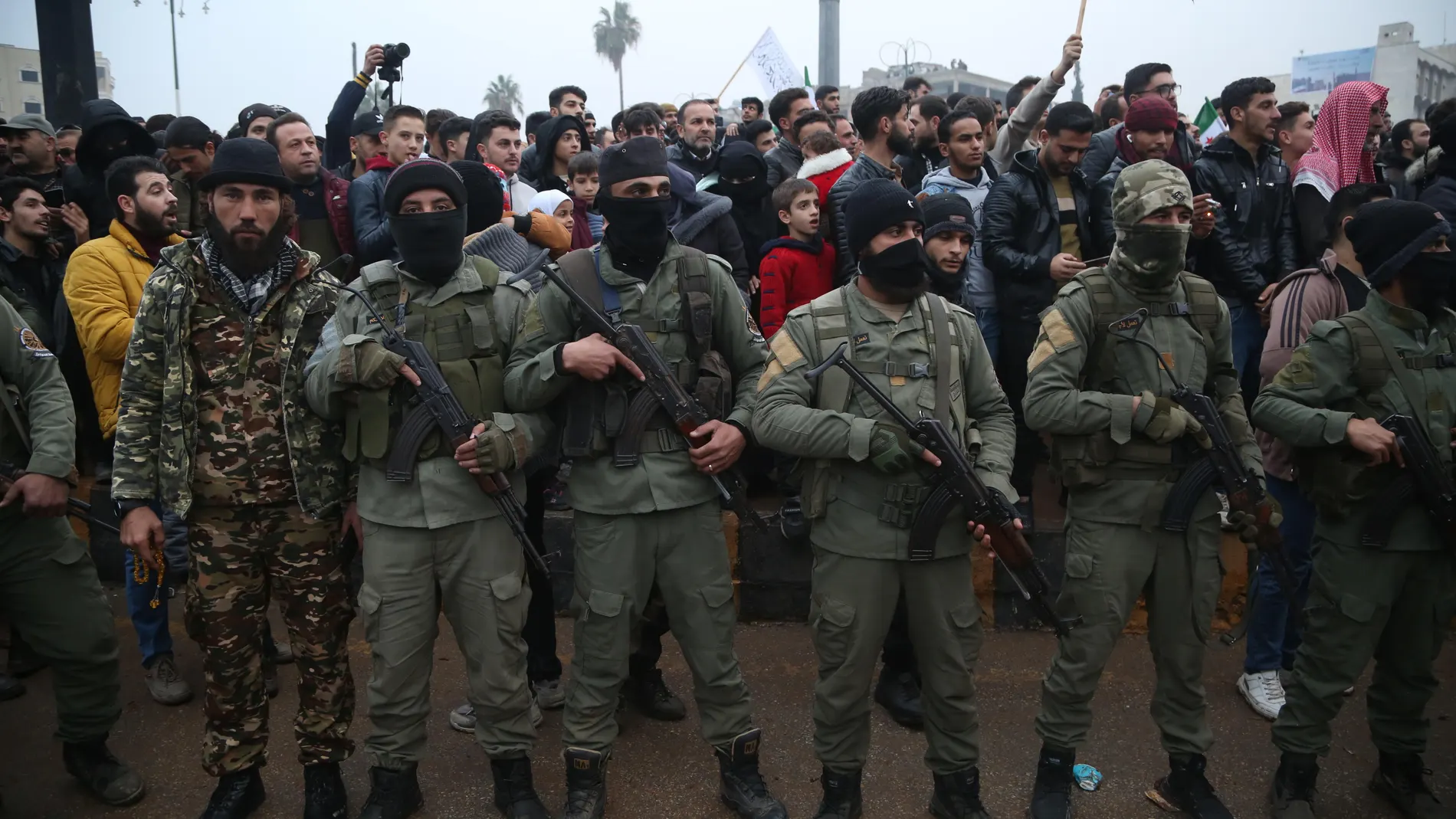 Idlib (Syrian Arab Republic), 22/12/2024.- Armed rebel fighters keep watch as people take part in a 'Liberation Festival' to celebrate the ouster of Syrian president Bashar Al-Assad, in Idlib, northwestern Syria, 22 December 2024. Idlib has been a stronghold for Hay'at Tahrir al-Sham (HTS), the rebel group that along with other Syrian opposition groups toppled the Assad regime on 08 December 2024. (Siria) EFE/EPA/BILAL AL HAMMOUD