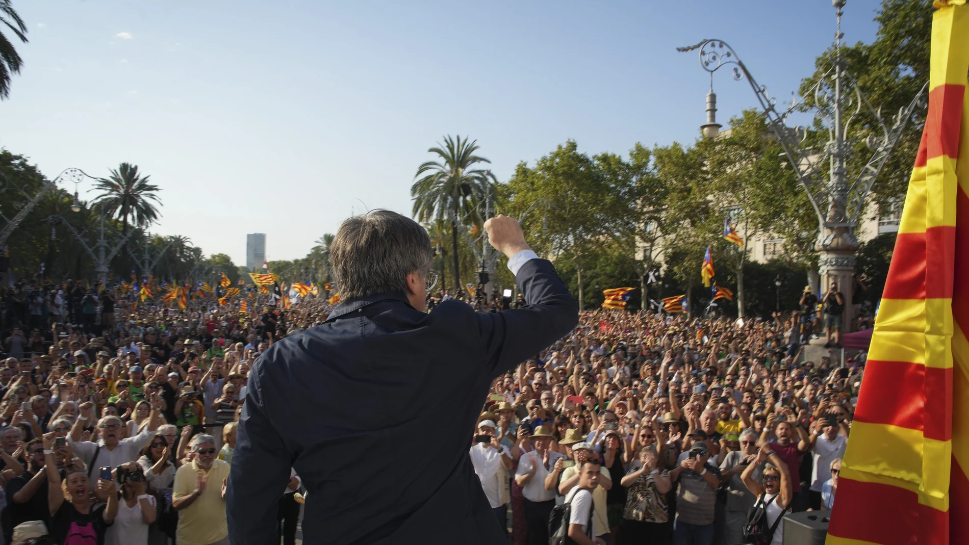 Catalan independence leader and former President Carles Puigdemont addresses supporters after his arrival near the Catalan parliament to attend the investiture debate in Barcelona, Spain