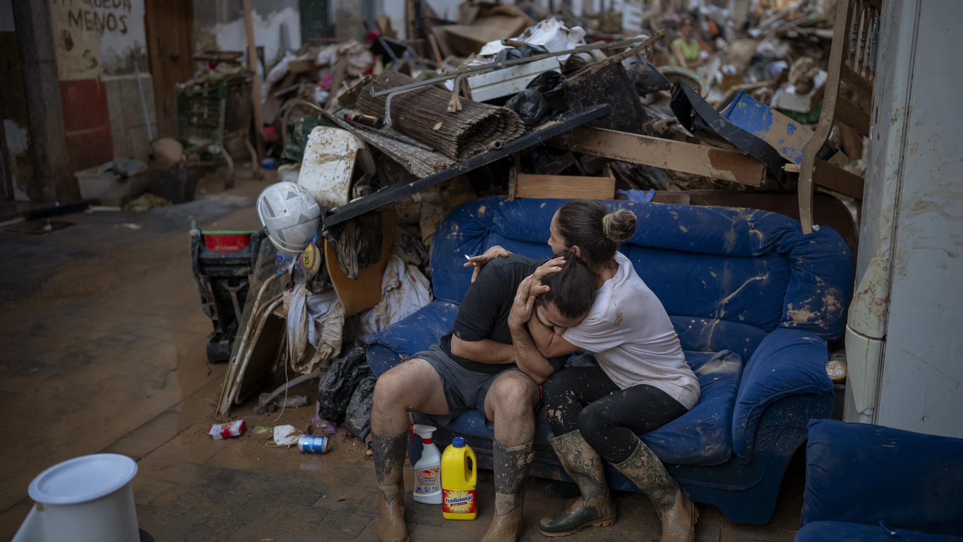Tania hugs her brother-in-law Baruc after rescuing some of their belongings from their flooded house after the floods in Paiporta, Valencia, Spain, Tuesday, Nov. 5, 2024.