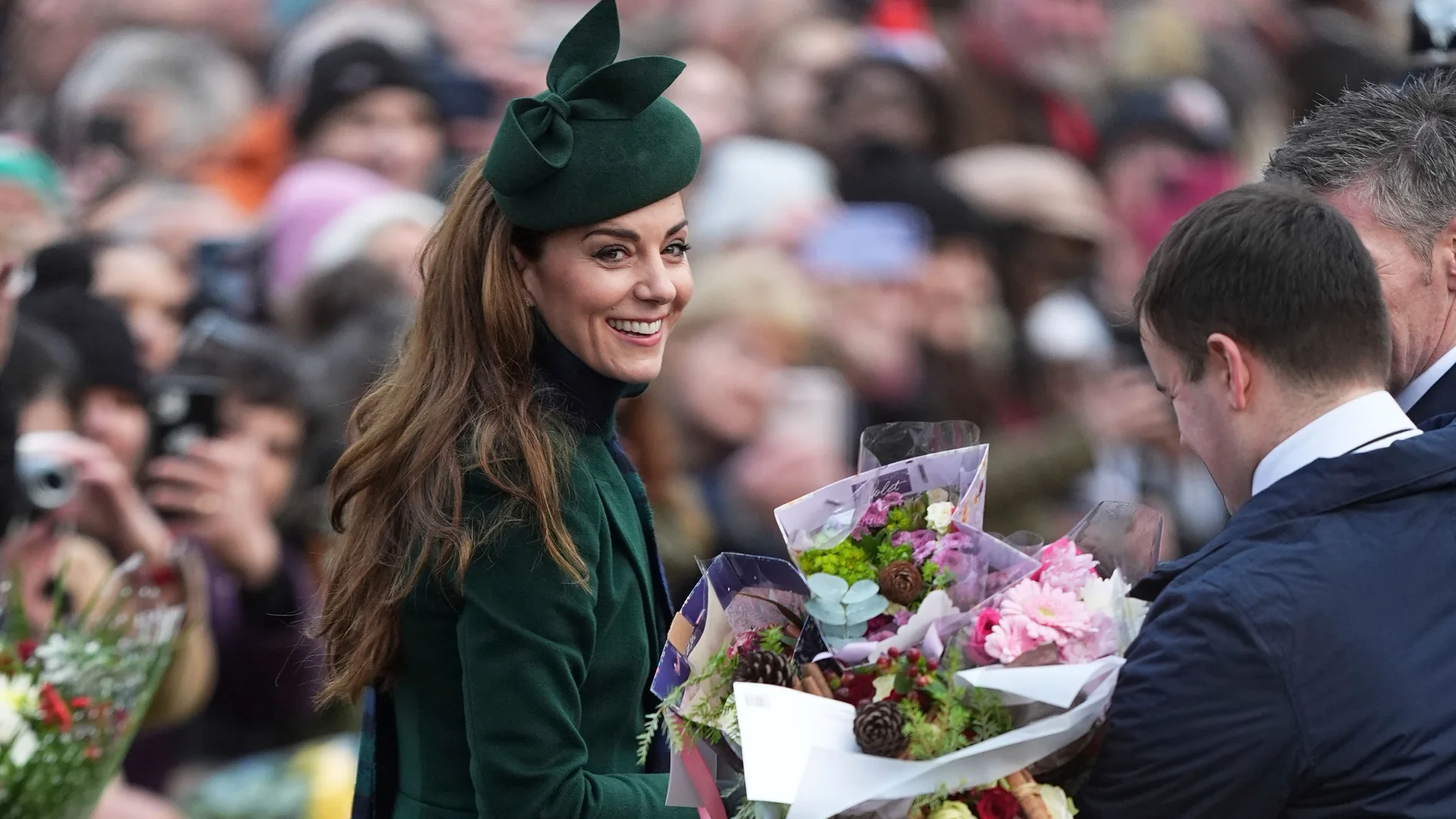 Kate Princess of Wales smiles as holds a bouquet of flowers gives to her by well-wishers after she attended the Christmas day service at St Mary Magdalene Church in Sandringham in Norfolk, England, Wednesday, Dec. 25, 2024. (Aaron Chown/PA via AP)