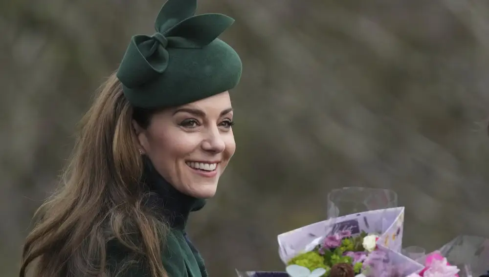 Kate Princess of Wales smiles as holds a bouquet of flowers gives to her by well-wishers after she attended the Christmas day service at St Mary Magdalene Church in Sandringham in Norfolk, England, Wednesday, Dec. 25, 2024.