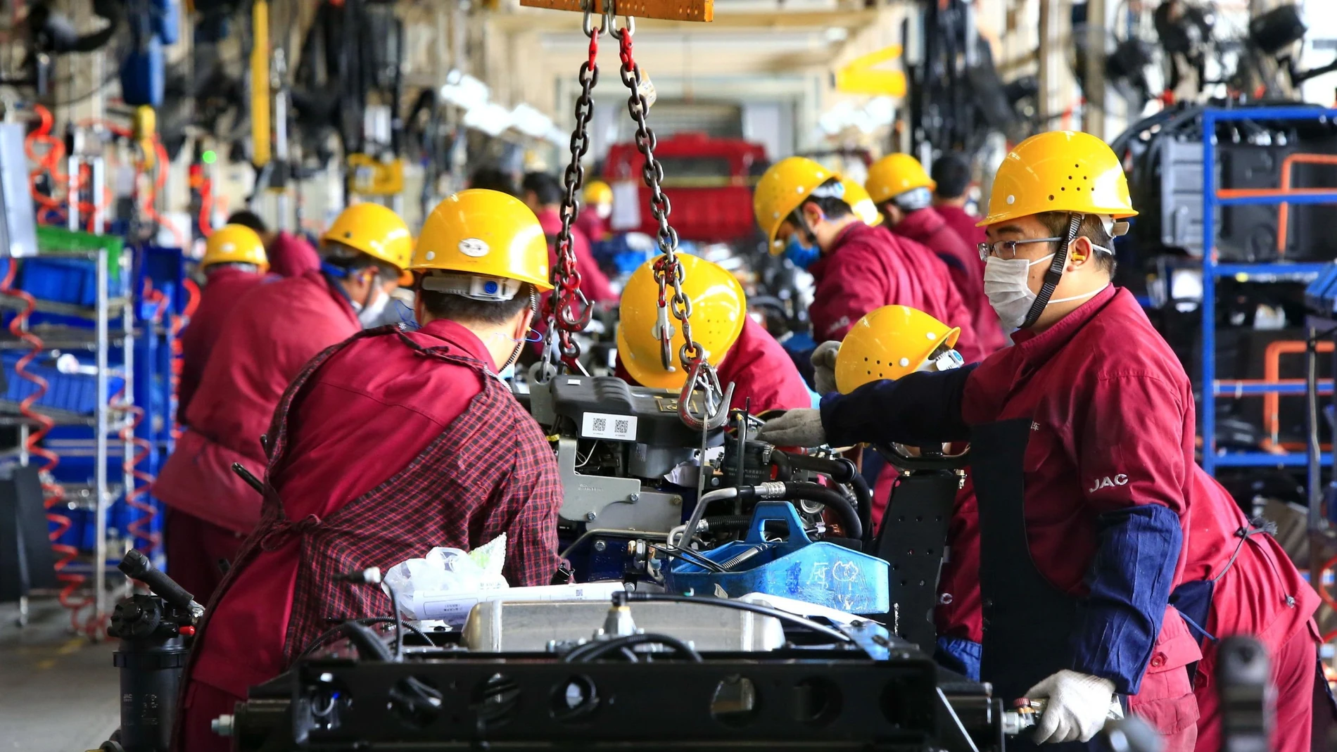 Workers assemble pickup trucks at a JAC Motors plant in Suining, Sichuan province, China