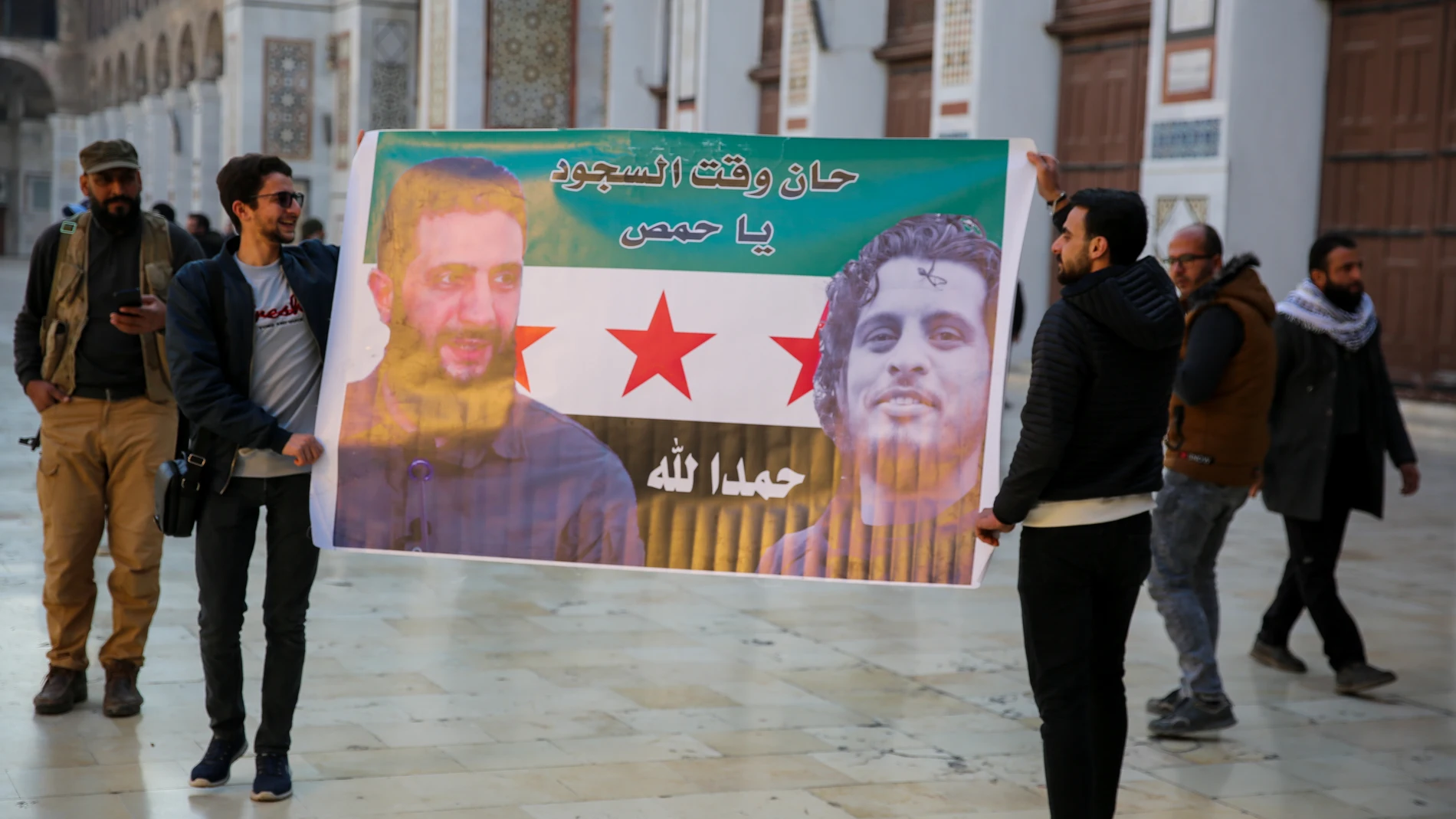 December 9, 2024: Damascus, Syria. 09 December 2024. A poster of the Syrian opposition flag with the image of HTS leader Abu Mohammed al-Jolani is displayed in the courtyard of the Omayyad Mosque in Damascus in the aftermath of the fall of the government of Bashar Al-Assad. Some opposition fighters were stationed at the mosque as several visitors entered the historic building following the overthrow of the Syrian regime by rebel forces led by Haya Tahrir al-ShamEuropa Press/Contacto/Juma Mo...