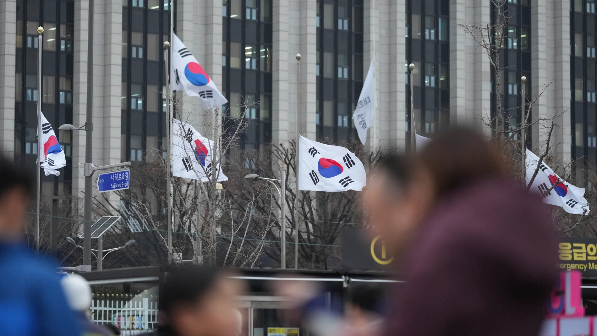 South Korean national flags fly at half-mast at the government complex, in Seoul, South Korea, Monday, Dec. 30, 2024. (AP Photo/Lee Jin-man)