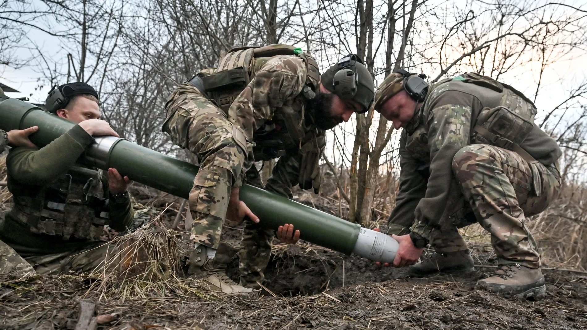 In the Donetsk region, Ukraine, on December 20, 2024, servicemen of Ukraine's Khyzhak Patrol Police Special Unit load a mortar while on a combat mission near Toretsk, Donetsk region, eastern Ukraine. (Photo by Ukrinform/NurPhoto) (Photo by Dmytro Smolienko / NurPhoto / NurPhoto via AFP)