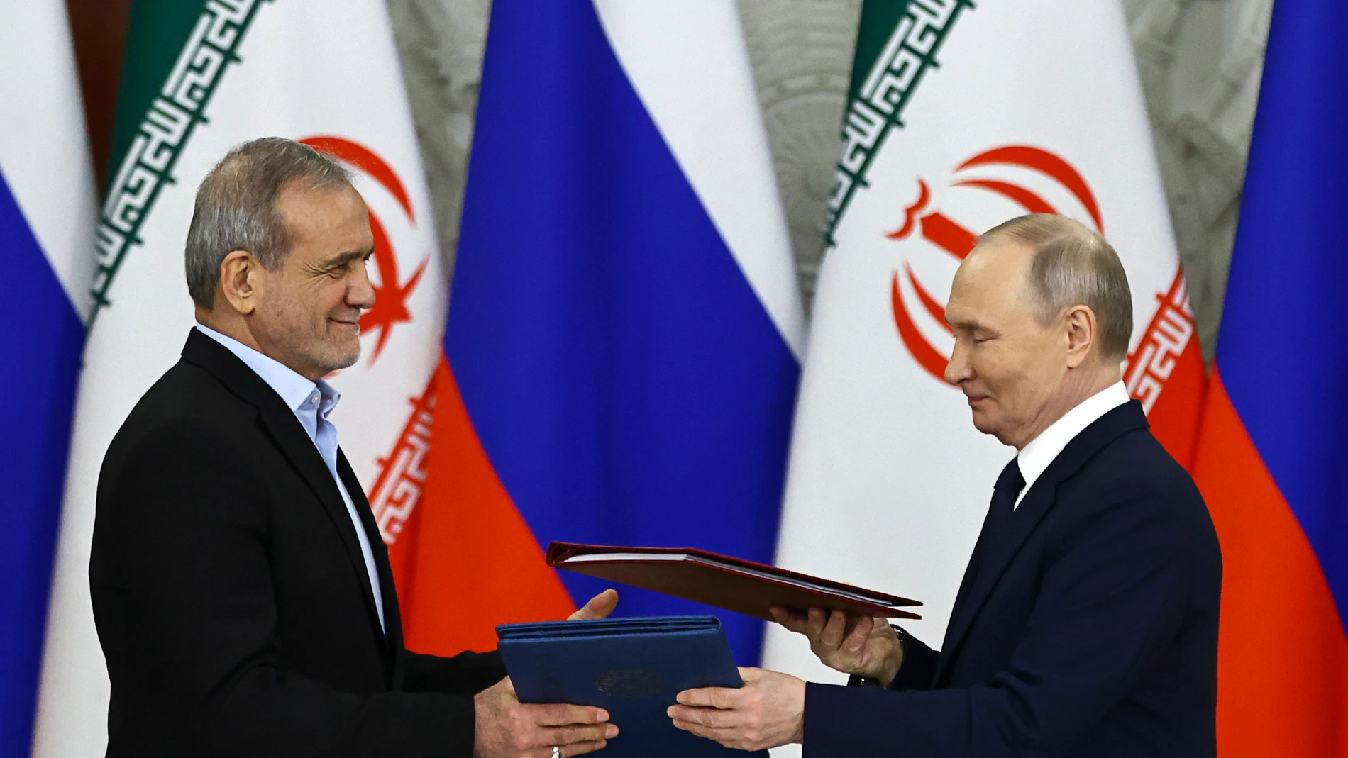 Russian President Vladimir Putin, right, and Iranian President Masoud Pezeshkian attend a signing ceremony at the Kremlin in Moscow, Russia, Friday, Jan. 17, 2025. (Evgenia Novozhenina/Pool Photo via AP)