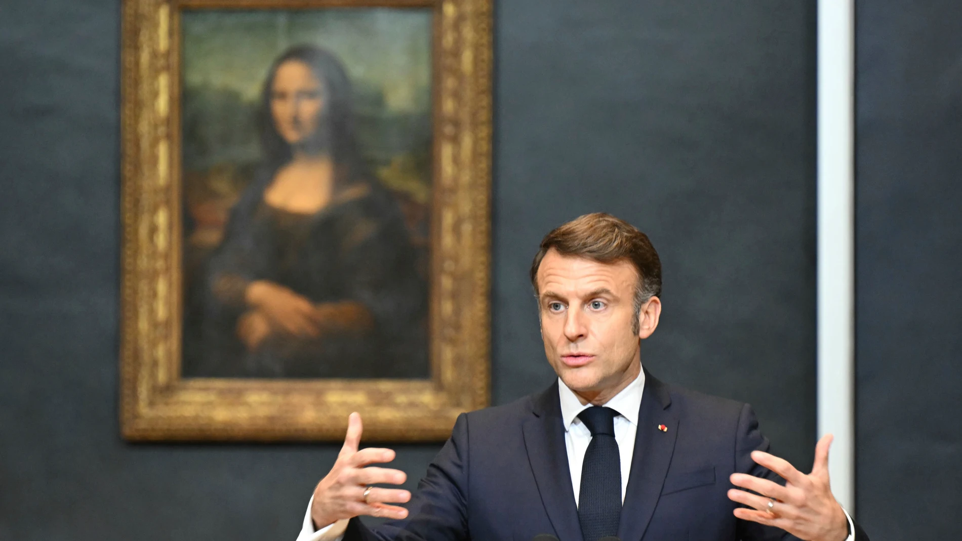 French President Emmanuel Macron gives a speech to announce a multi-year overhaul, long-term investments to modernize the Louvre museum, next to Leonardo da Vinci's painting of the Mona Lisa, at the Louvre Museum, Tuesday, Jan. 28, 2025 in Paris. ( Bertrand Guay, Pool via AP)