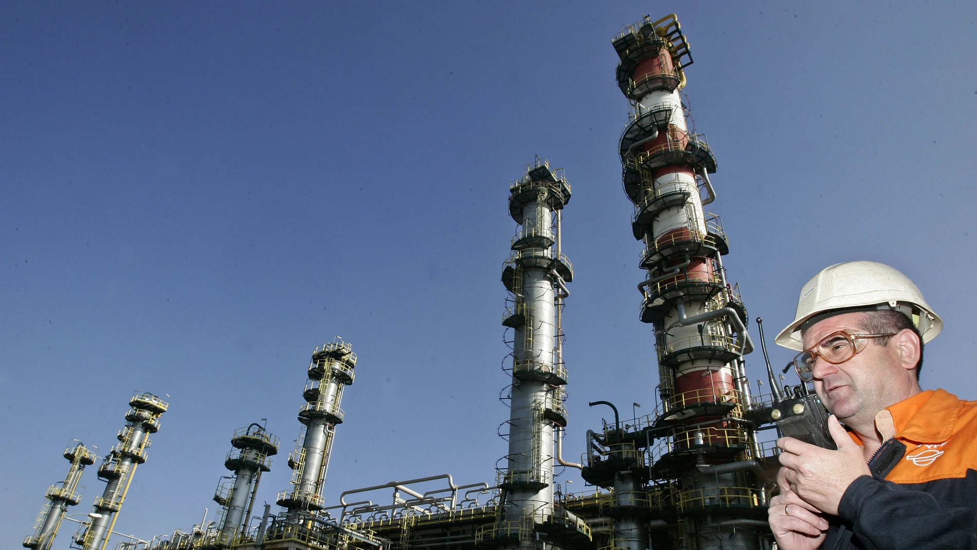 A worker of the Repsol refinery is seen speaking with a walkie talkie in Tarragona, Spain.