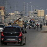 Palestinians make their way along Salah Al Din road