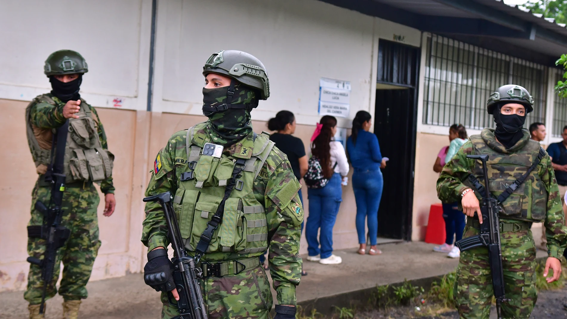 Soldiers guard a polling station before Luisa Gonzalez, the presidential candidate for the Citizen Revolution Movement, casts her ballot in the presidential election in Canuto, Ecuador, Sunday, Feb. 9, 2025. (AP Photo/Jairo Mendoza)