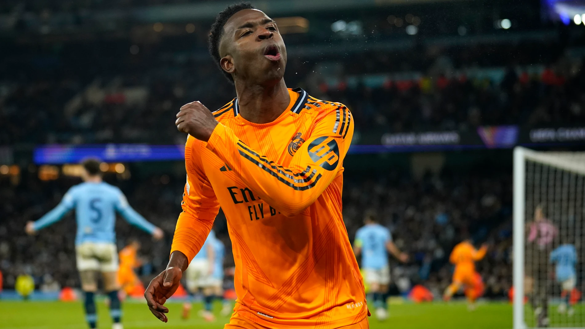 Real Madrid's Vinicius Junior celebrates after his teammate Real Madrid's Brahim Diaz scored their side second goal during the Champions League playoff first leg soccer match between Manchester City and Real Madrid at the Etihad Stadium in Manchester, England, Tuesday, Feb. 11, 2025. (AP Photo/Dave Thompson)