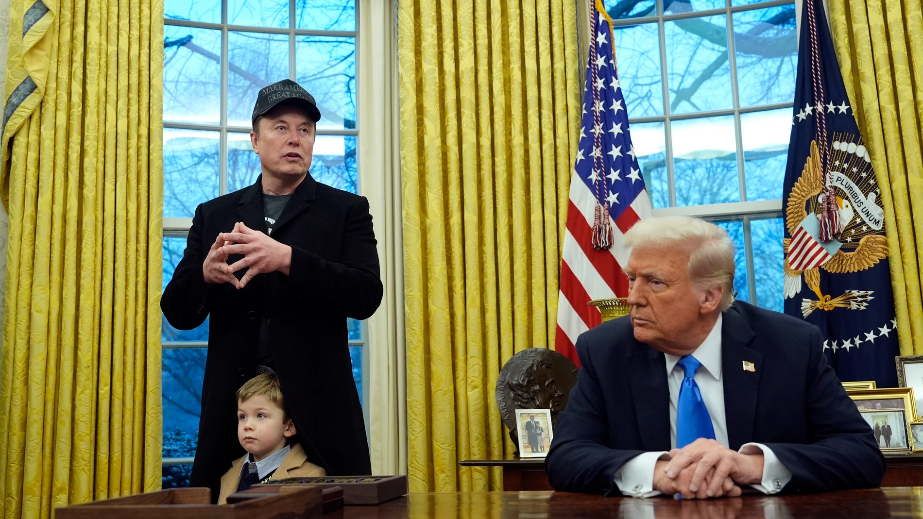 President Donald Trump listens as Elon Musk, joined by his son X Æ A-Xii, speaks in the Oval Office at the White House, Tuesday, Feb. 11, 2025, in Washington. (Photo/Alex Brandon)