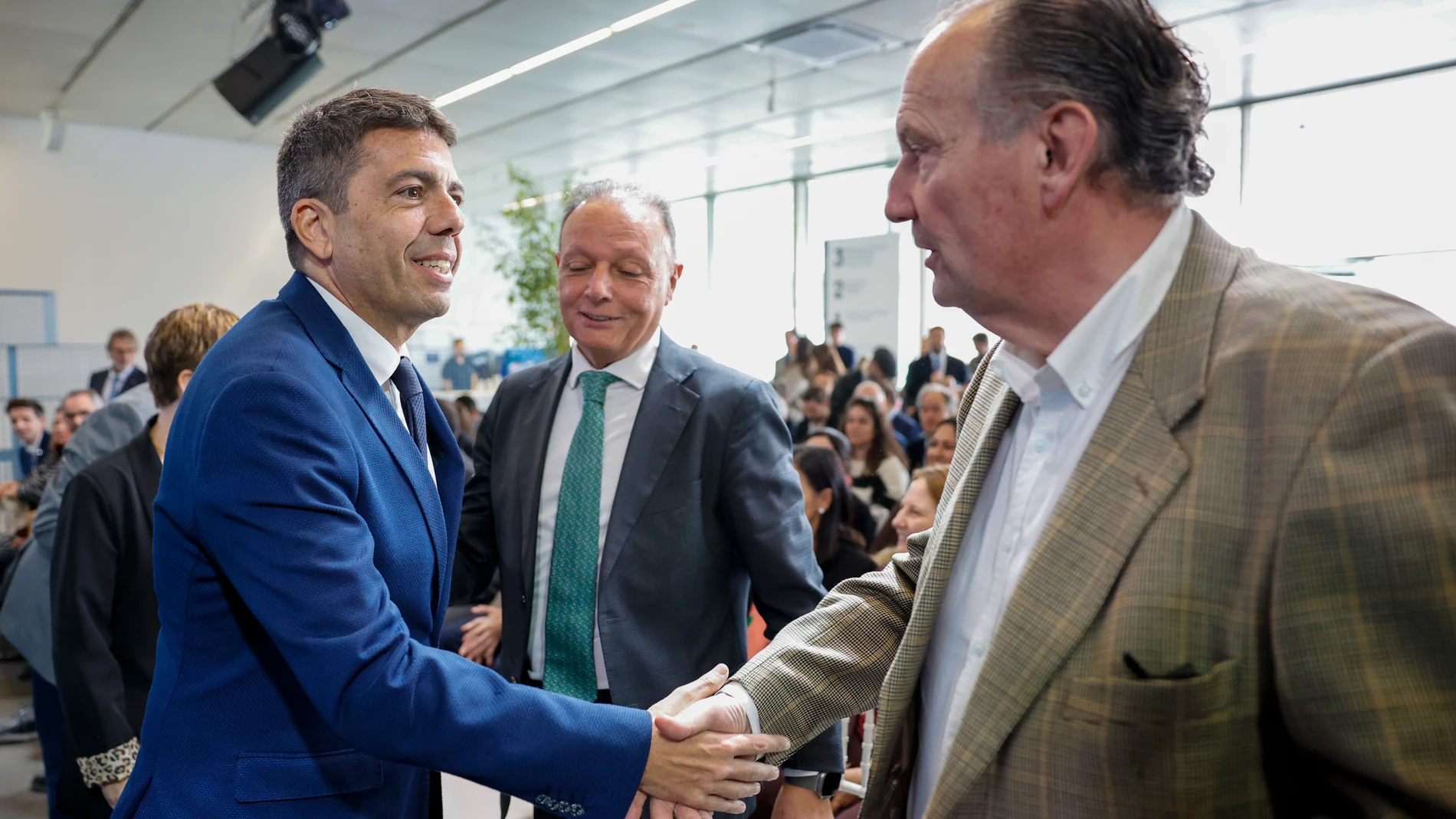 El presidente Mazón saluda al presidente de la Cámara de Comercio de Valencia, José Vicente Morata ante la mirada de Salvador Navarro (CEV)