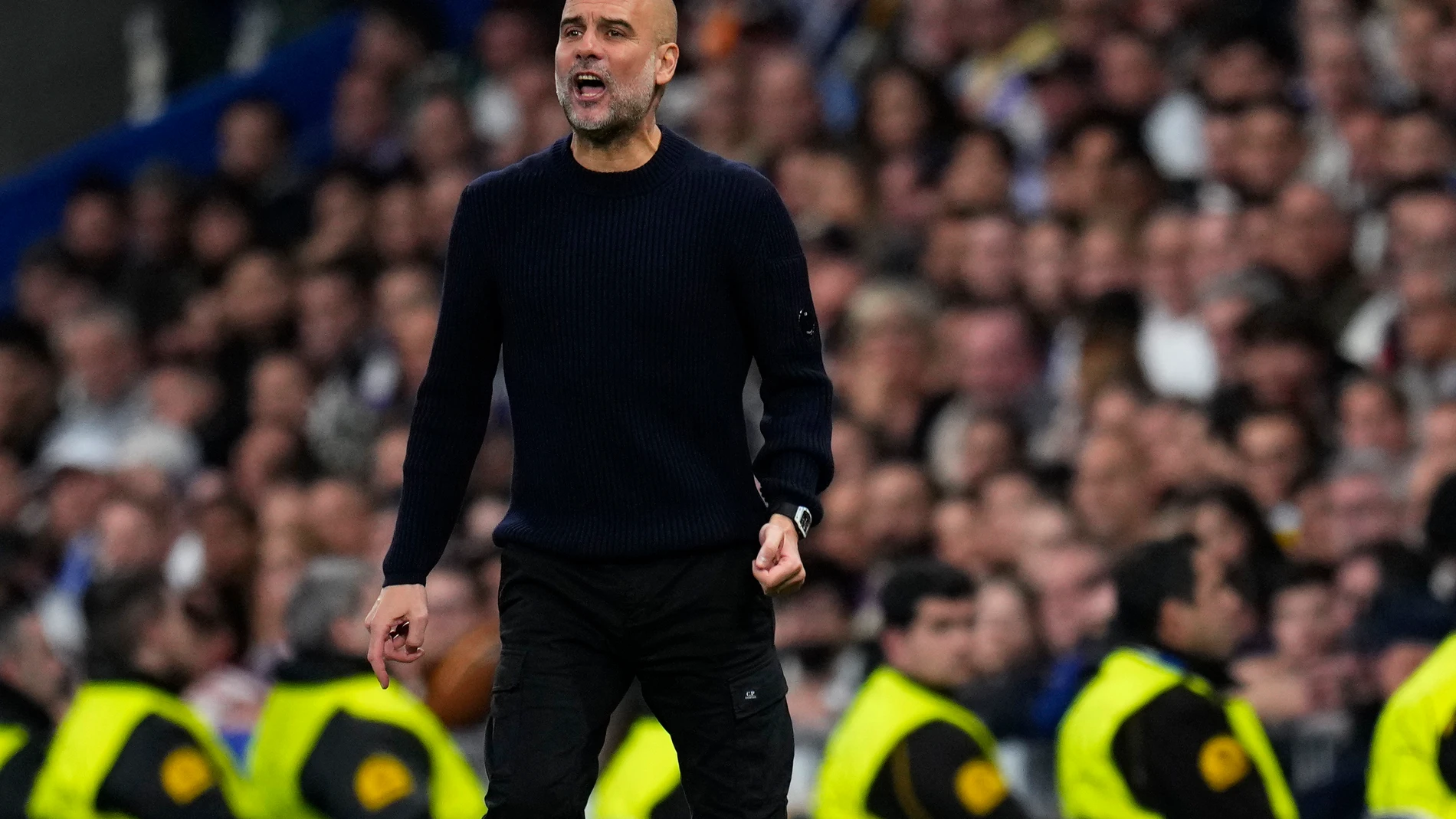 Manchester City's head coach Pep Guardiola shouts during the Champions League playoff second leg soccer match between Real Madrid and Manchester City at the Santiago Bernabeu Stadium in Madrid, Spain, Wednesday, Feb. 19, 2025. (AP Photo/Manu Fernandez)