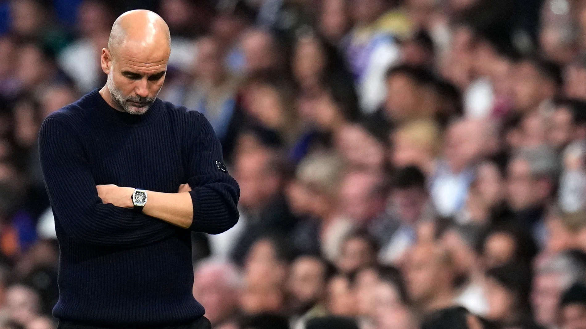 Manchester City's head coach Pep Guardiola grimaces during the Champions League playoff second leg soccer match between Real Madrid and Manchester City at the Santiago Bernabeu Stadium in Madrid, Spain, Wednesday, Feb. 19, 2025. (AP Photo/Manu Fernandez)