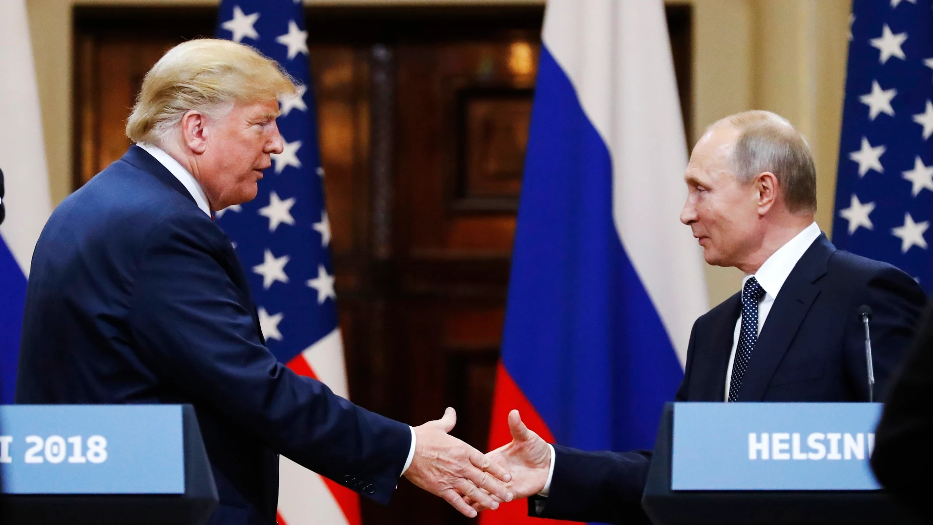 FILE - In this file photo taken on Monday, July 16, 2018, U.S. President Donald Trump shakes hand with Russian President Vladimir Putin at the end of the press conference after their meeting at the Presidential Palace in Helsinki, Finland. (AP Photo/Alexander Zemlianichenko, File)