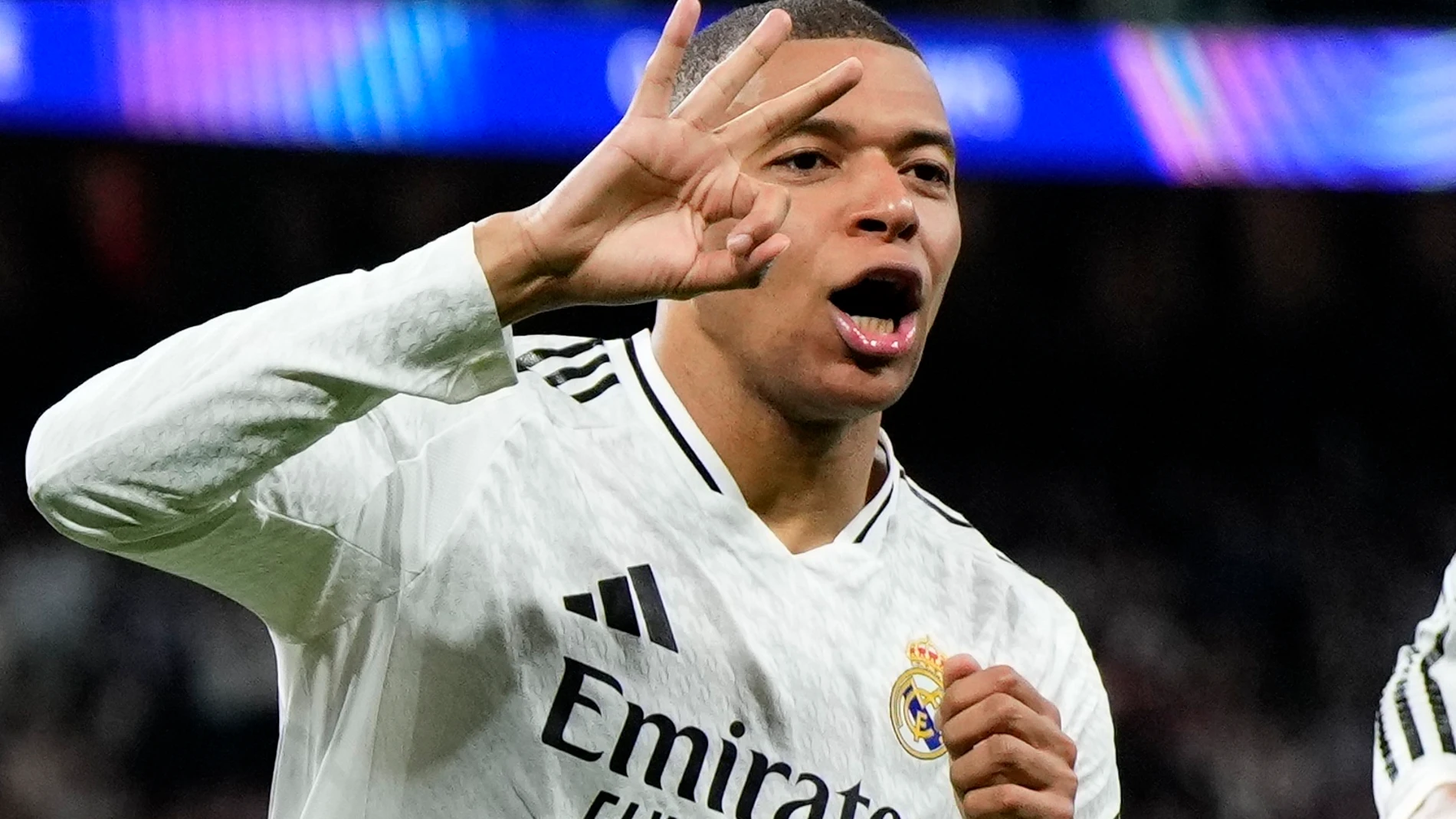 Real Madrid's Kylian Mbappe celebrates with Real Madrid's Jude Bellingham, right, after scoring his sides third goal during the Champions League playoff second leg soccer match between Real Madrid and Manchester City at the Santiago Bernabeu Stadium in Madrid, Spain, Wednesday, Feb. 19, 2025. (AP Photo/Manu Fernandez)