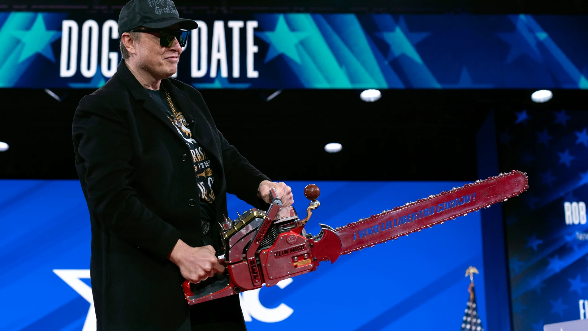 Elon Musk hold a chainsaw as he arrives to speak at the Conservative Political Action Conference, CPAC, at the Gaylord National Resort & Convention Center, Thursday, Feb. 20, 2025, in Oxon Hill, Md. (AP Photo/Jose Luis Magana)