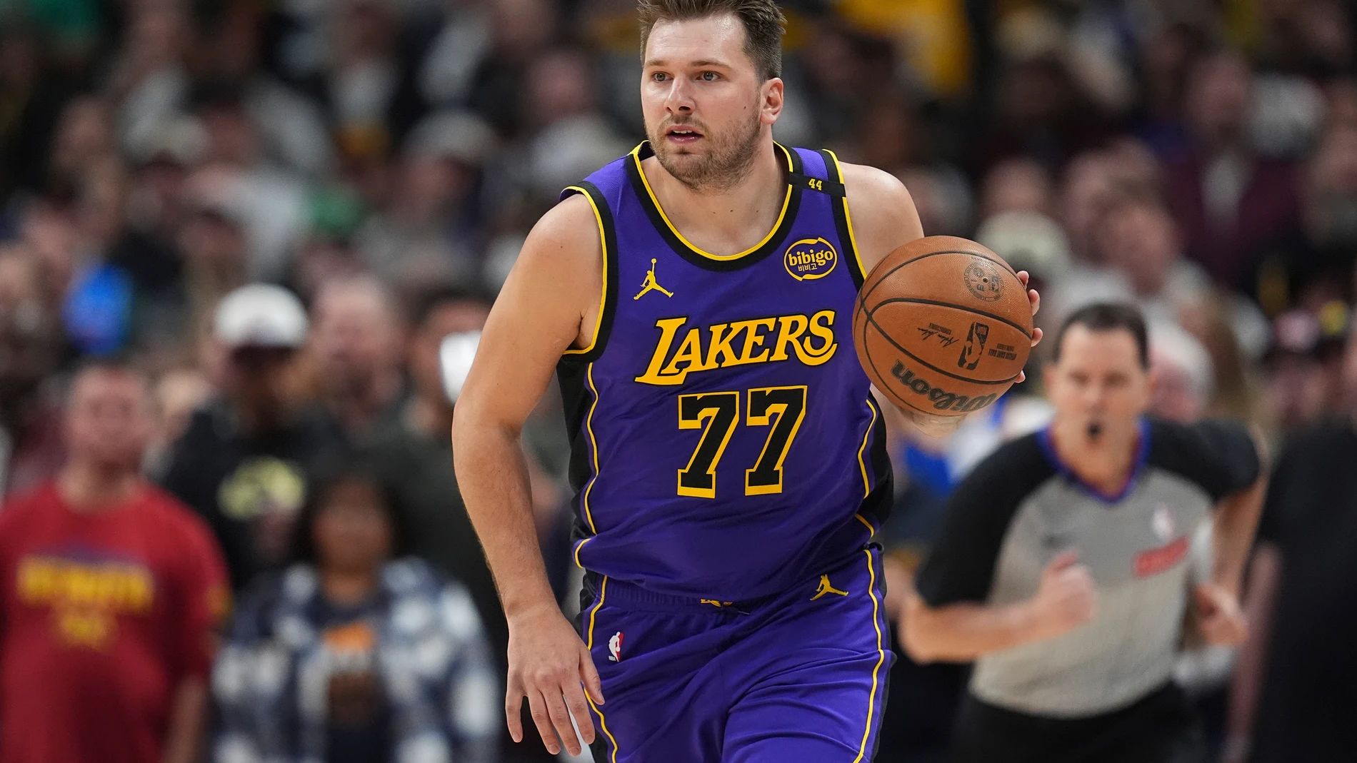 Los Angeles Lakers guard Luka Doncic brings the ball up the court against the Denver Nuggets in the first half of an NBA basketball game Saturday, Feb. 22, 2025, in Denver. (AP Photo/David Zalubowski)