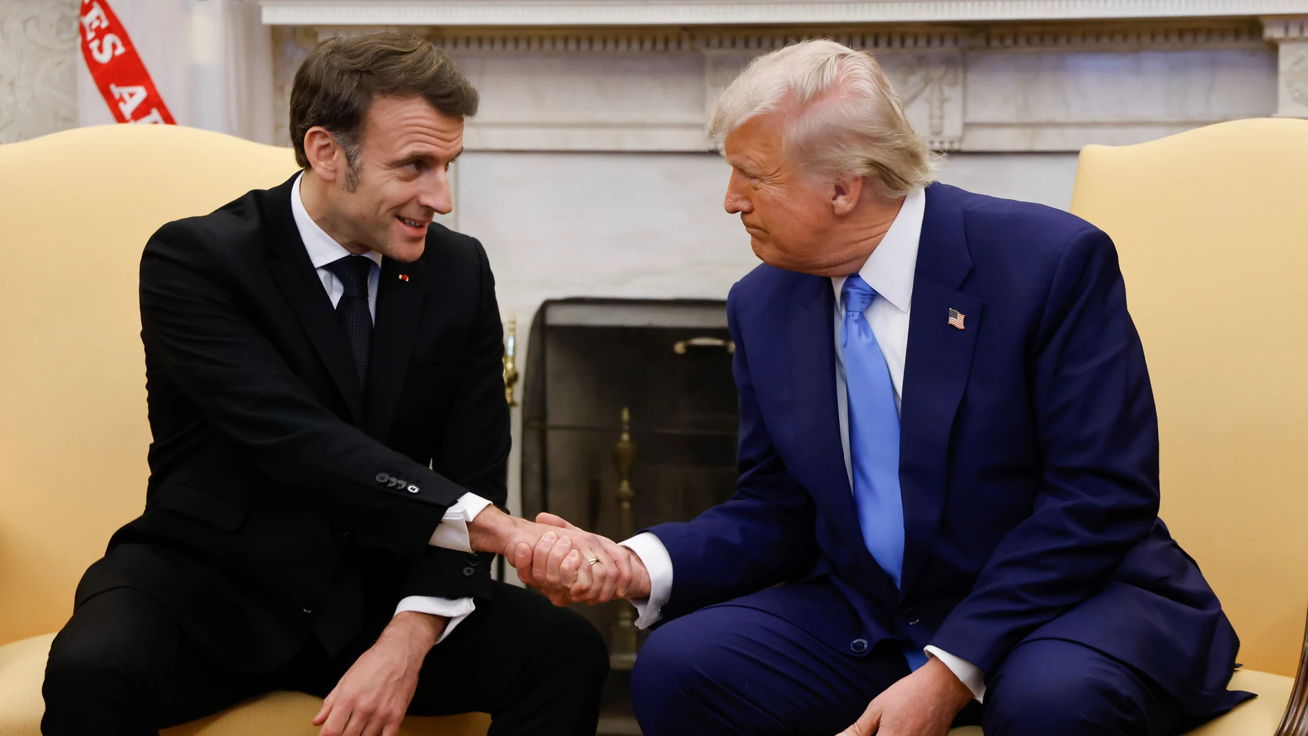 President Donald Trump, right, shakes the hand of France's President Emmanuel Macron during a meeting in the Oval Office of the White House in Washington, Monday, Feb. 24, 2025. (Ludovic Marin/Pool via AP)