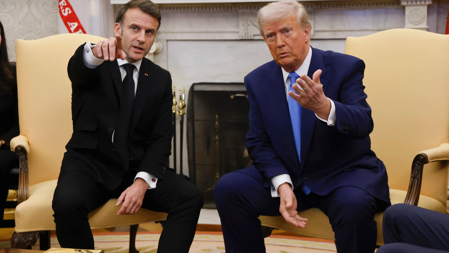 President Donald Trump, right, and France's President Emmanuel Macron speak in the Oval Office of the White House in Washington, Monday, Feb. 24, 2025. (Ludovic Marin/Pool via AP)