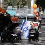 People gather in Tel Aviv to watch Bibas family funeral