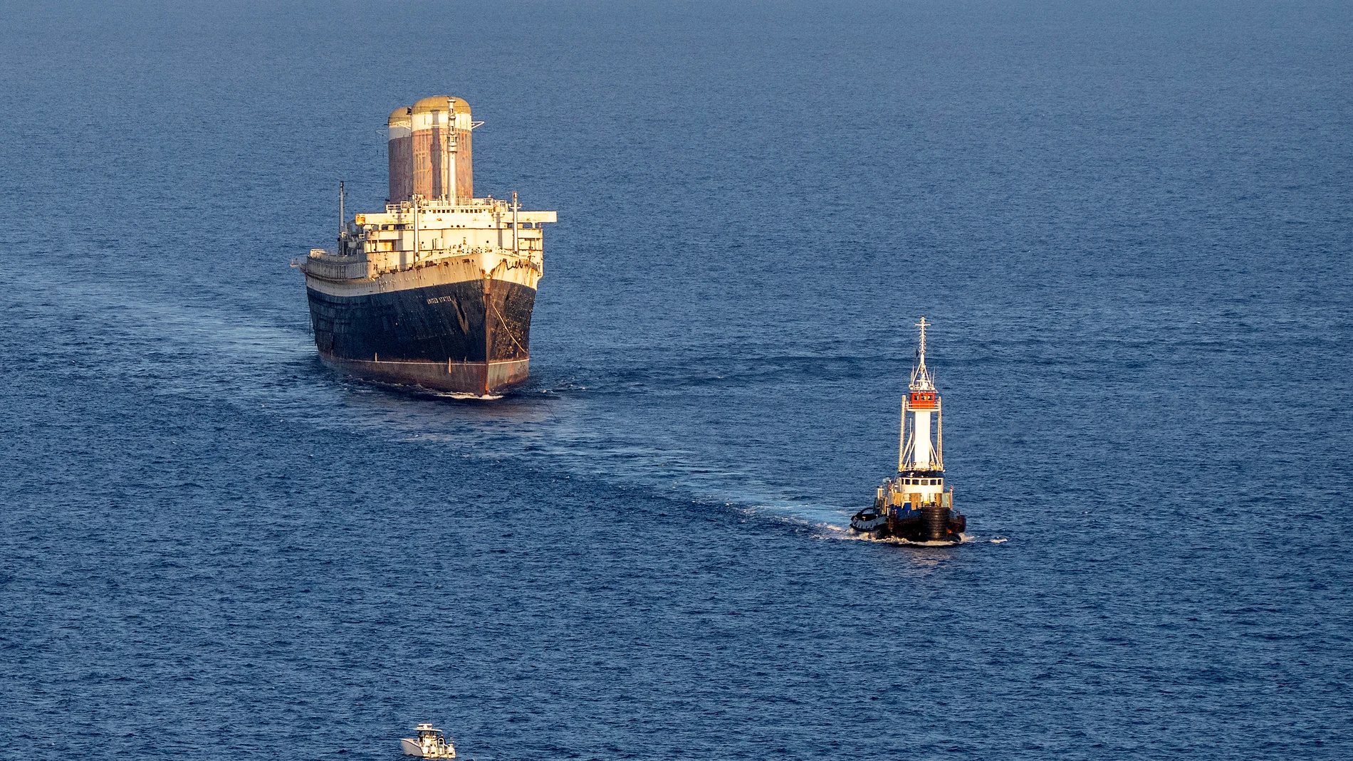 The SS United States is towed at sunset past Key West, Fla., headed to Mobile, Ala., Thursday, Feb. 27, 2025, where it will be prepared to be used as an artificial reef. (Rob O'Neal/The Key West Citizen via AP)
