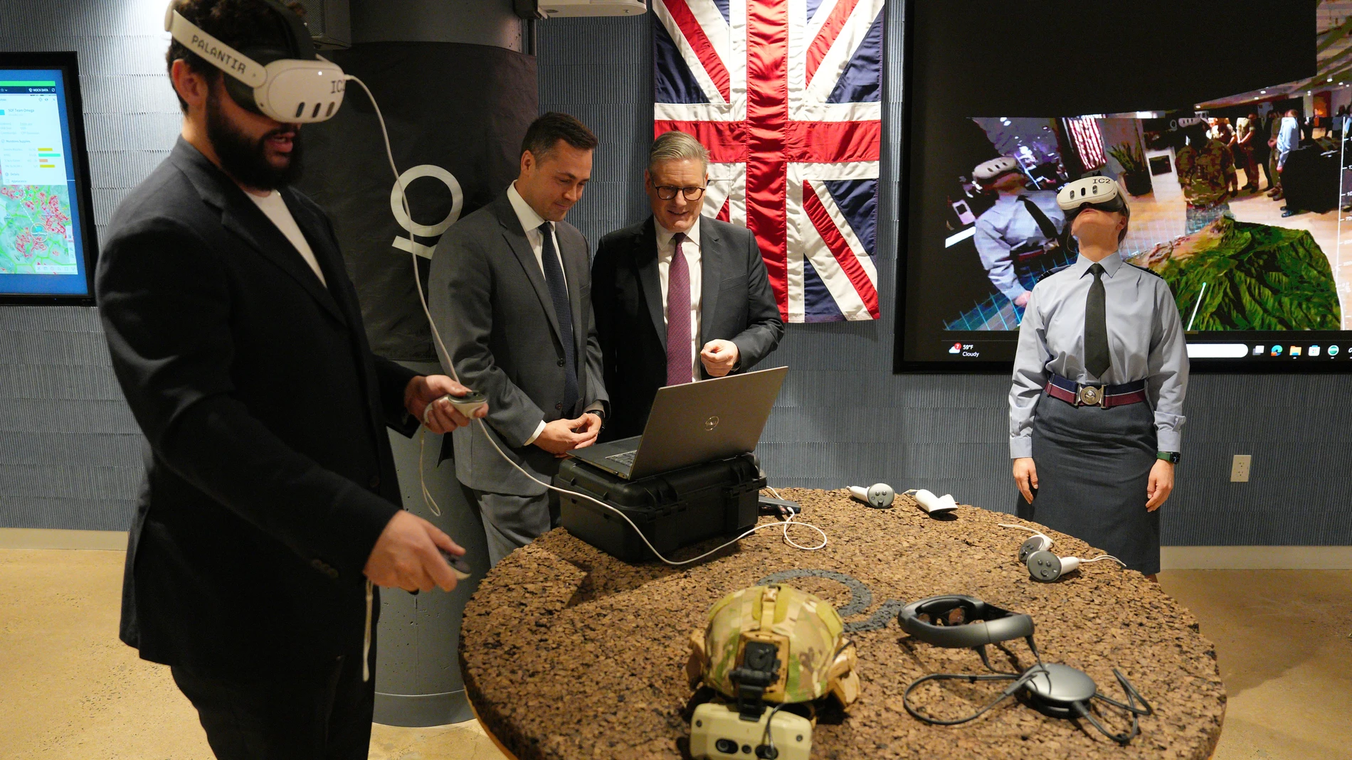Britain's Prime Minister Keir Starmer, third left, tours Palantir Technologies headquarters with company employees and British military personnel Thursday, Feb. 27, 2025, in Washington. (Carl Court/Pool Photo via AP)