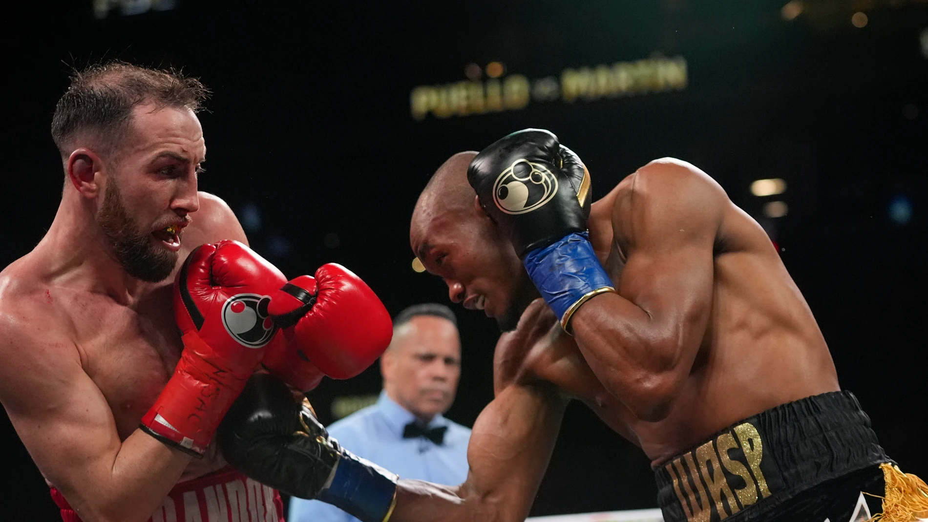 Dominican Republic's Alberto Puello, right, punches Spain's Sandor Martin during the ninth round of a WBC super lightweight championship boxing bout Saturday, March 1, 2025, in New York. (AP Photo/Frank Franklin II)