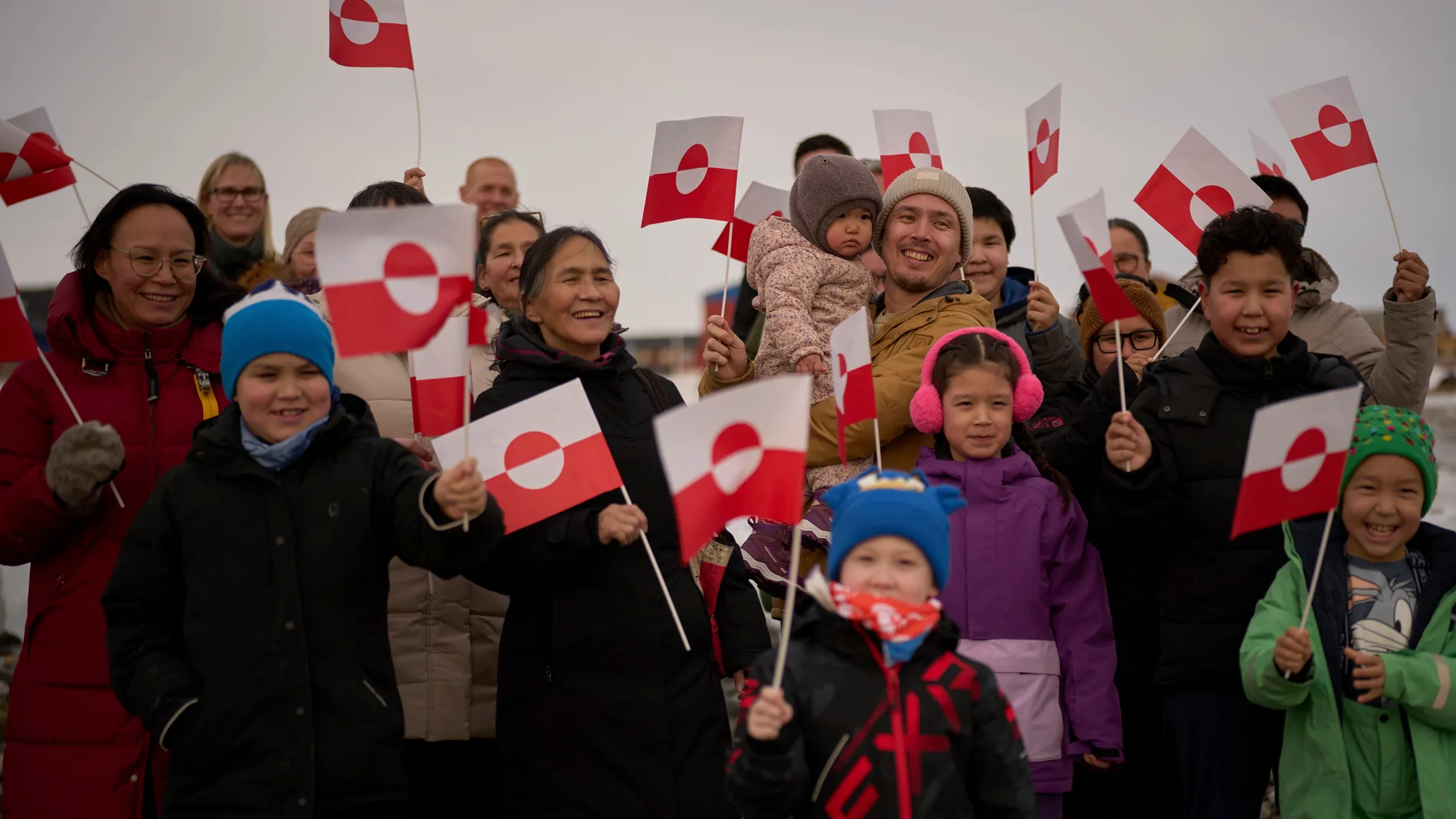 People wave Greenland flags during an event organized by Qupanuk Olsen, Greenland's most popular social media influencer and a candidate for the Naleraq party in the next March 11 election, in Nuuk, Greenland, Sunday, Feb. 16, 2025. (AP Photo/Emilio Morenatti)