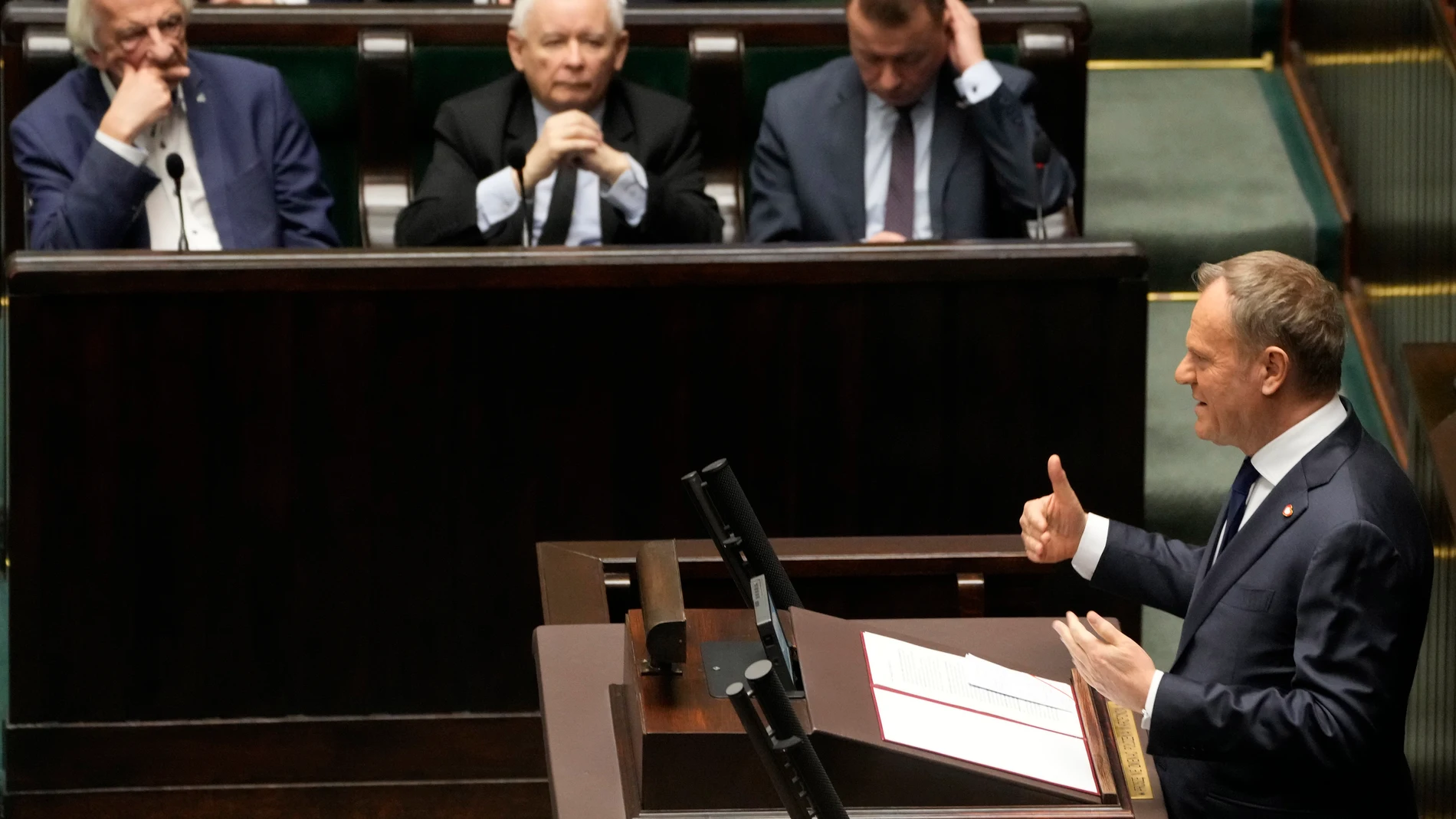 Polish Prime Minister Donald Tusk, right, speaks at the Sejm, the lower house of parliament, in Warsaw, Poland, Friday March 7, 2025. (AP Photo/Czarek Sokolowski)