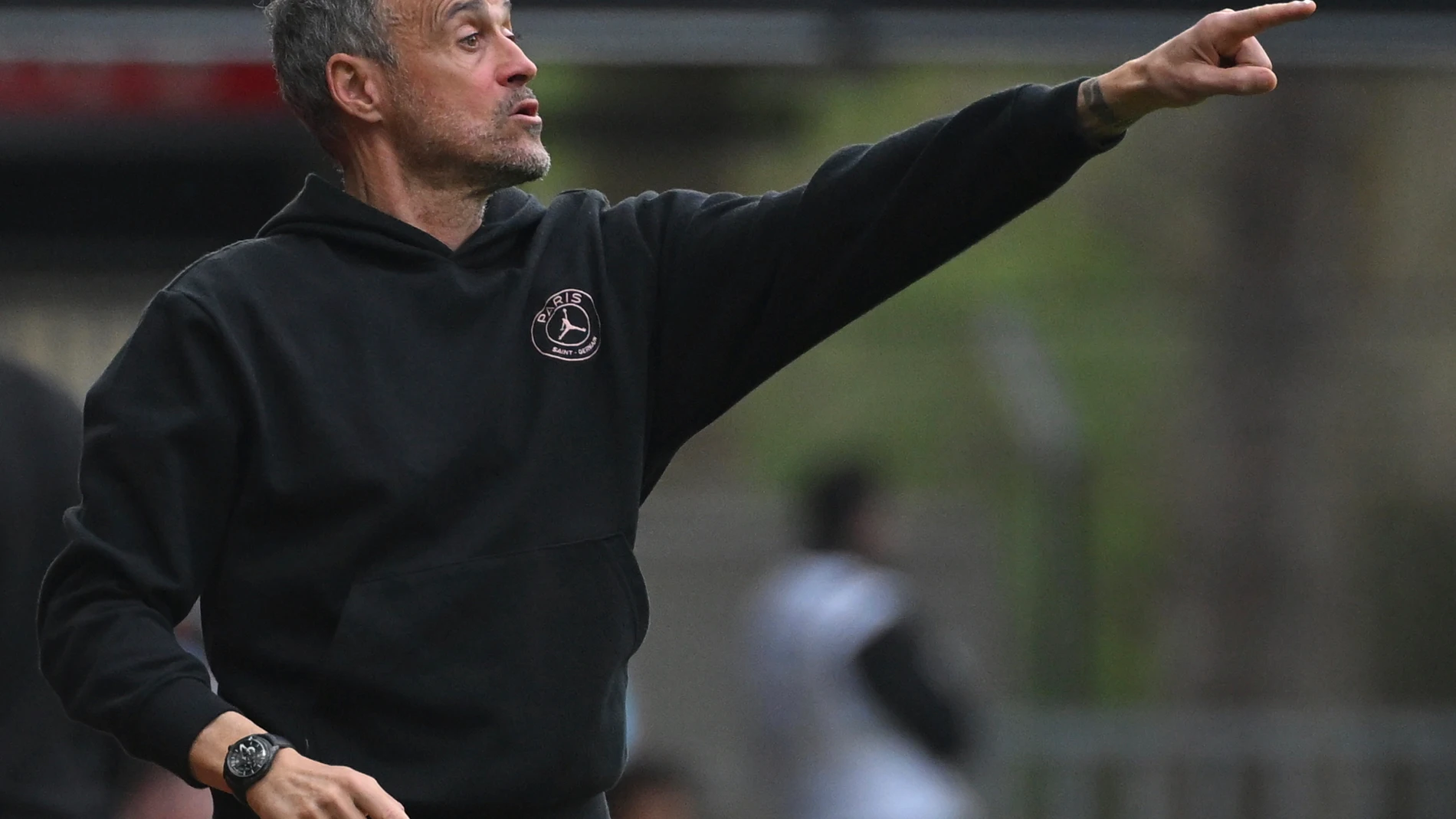 PSG's head coach Luis Enrique points during the French League One soccer match between Rennes and Paris Saint-Germain at Roazhon Park stadium in Rennes, France, Saturday March 8, 2025. (AP Photo/Matthieu Mirville)