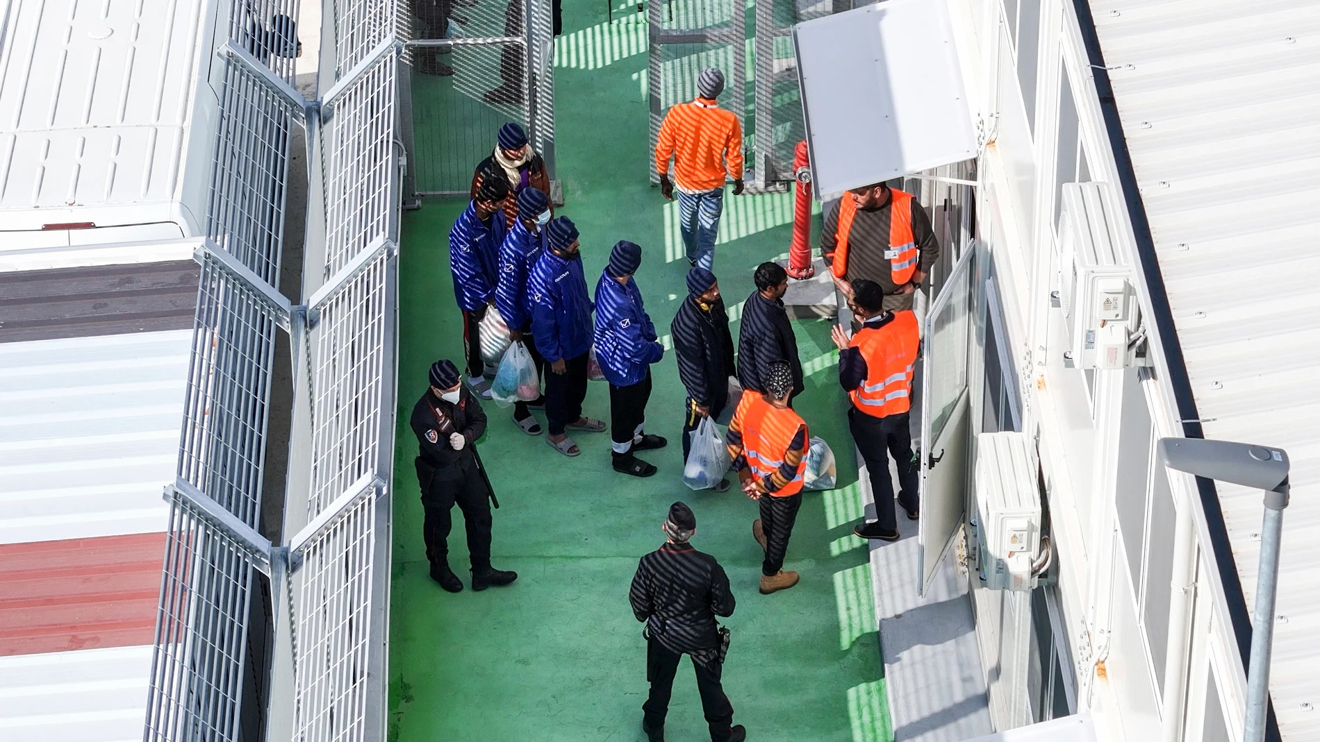 FILE -An aerial photograph taken by a drone shows migrants entering a detention center for processing following earlier court rejections, in the port of Shengjin, northwestern Albania, Tuesday, Jan. 28, 2025. (AP Photo/Vlasov Sulaj, File)