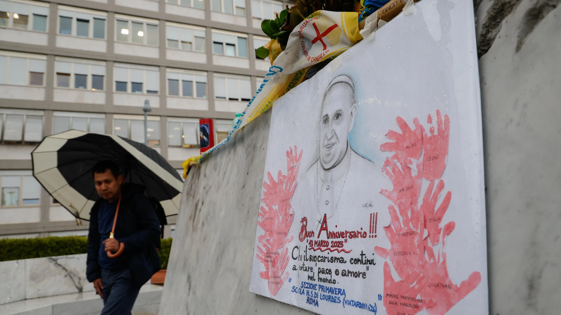 Rome (Italy), 12/03/2025.- A man walks past the statue of John Paul II outside the Agostino Gemelli Hospital, where Pope Francis remains hospitalized, in Rome, Italy, 12 March 2025. Pope Francis was admitted to Rome's Gemelli Hospital on 14 February due to a respiratory tract infection. (Papa, Italia, Roma) EFE/EPA/GIUSEPPE LAMI