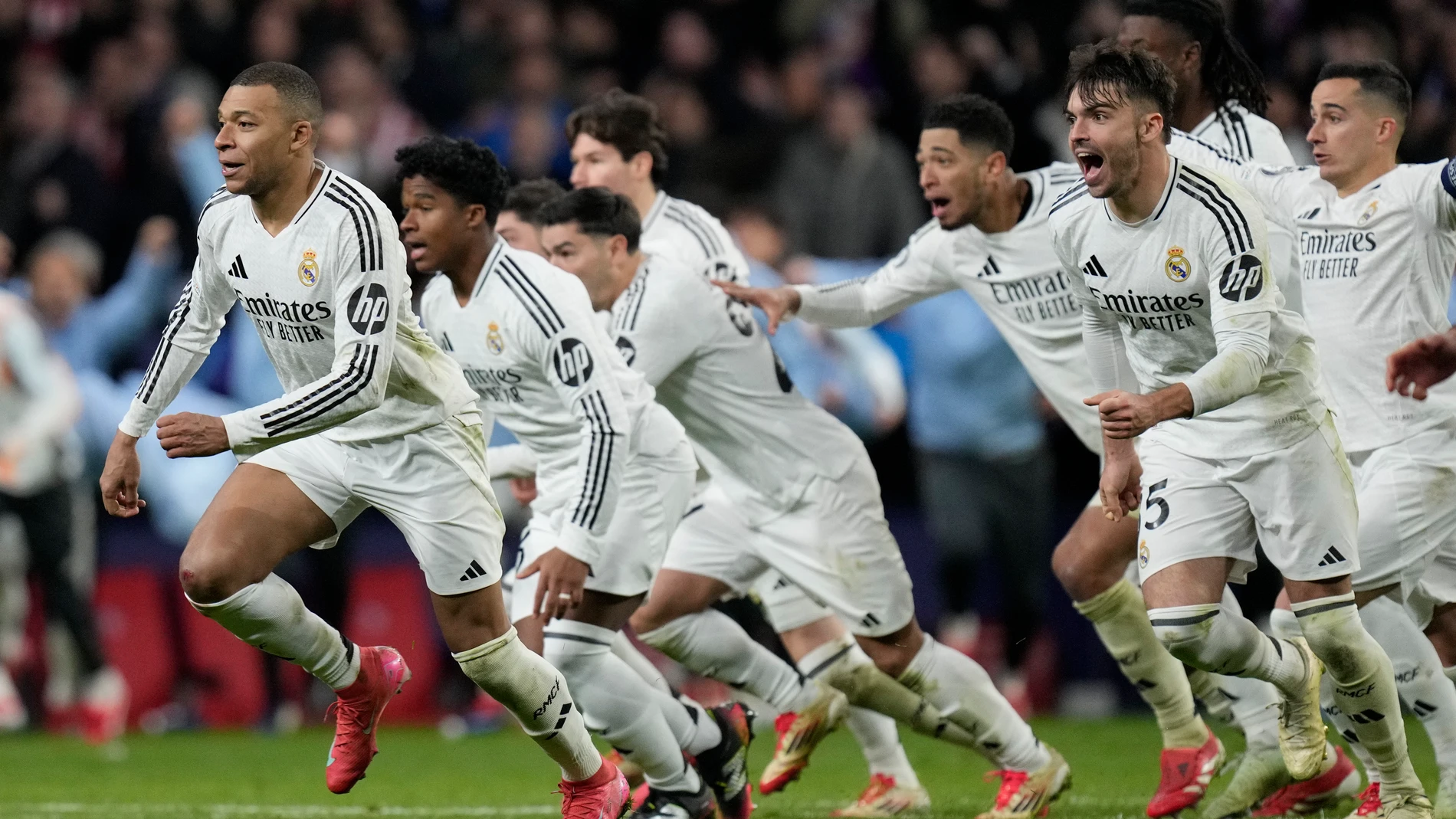 Real Madrid players celebrate after winning the penalty shootout during the Champions League round of 16, second leg, soccer match between Atletico Madrid and Real Madrid at the Metropolitano stadium in Madrid, Spain, Wednesday, March 12, 2025. (AP Photo/Bernat Armangue)