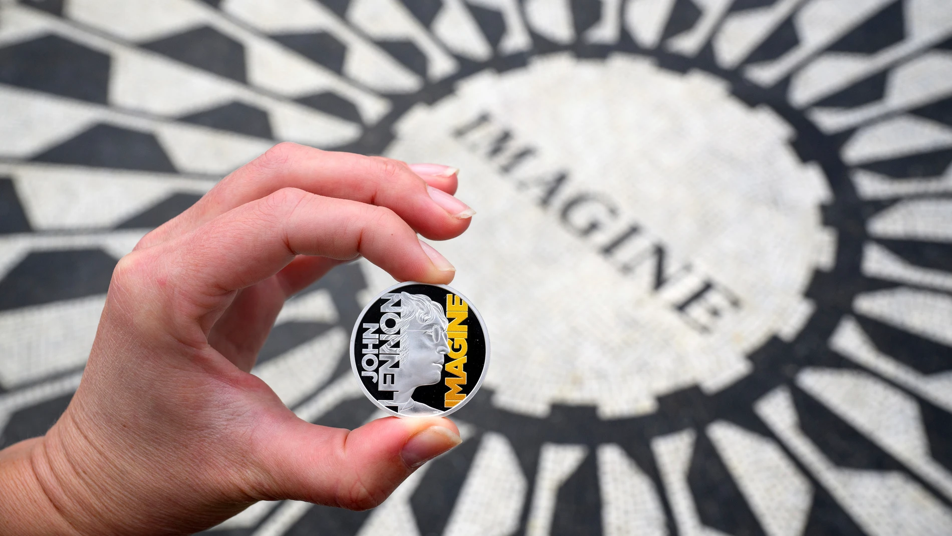 A specially minted British coin to mark the year the Beatles legend and peace advocate John Lennon is displayed in the Strawberry Fields section of Central Park, dedicated to the former Beatle, March 5, 2025, in New York. (Matt Crossick/PA Media Assignments via AP)