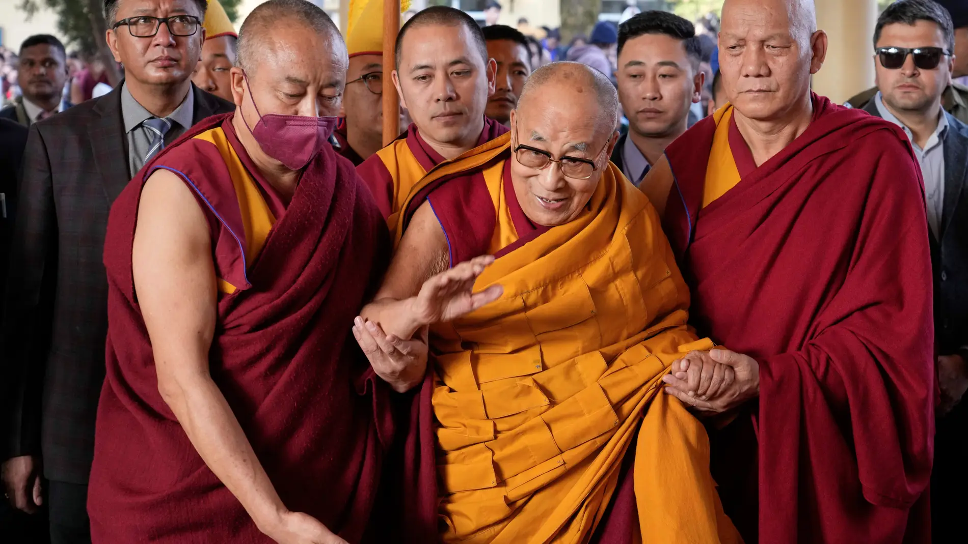 Tibetan spiritual leader the Dalai Lama, in yellow robe, arrives to give a sermon on the 15th day of the Tibetan New Year at the Tsuglakhang temple in Dharamshala, India, Friday, March 14, 2025. (AP Photo/Ashwini Bhatia)