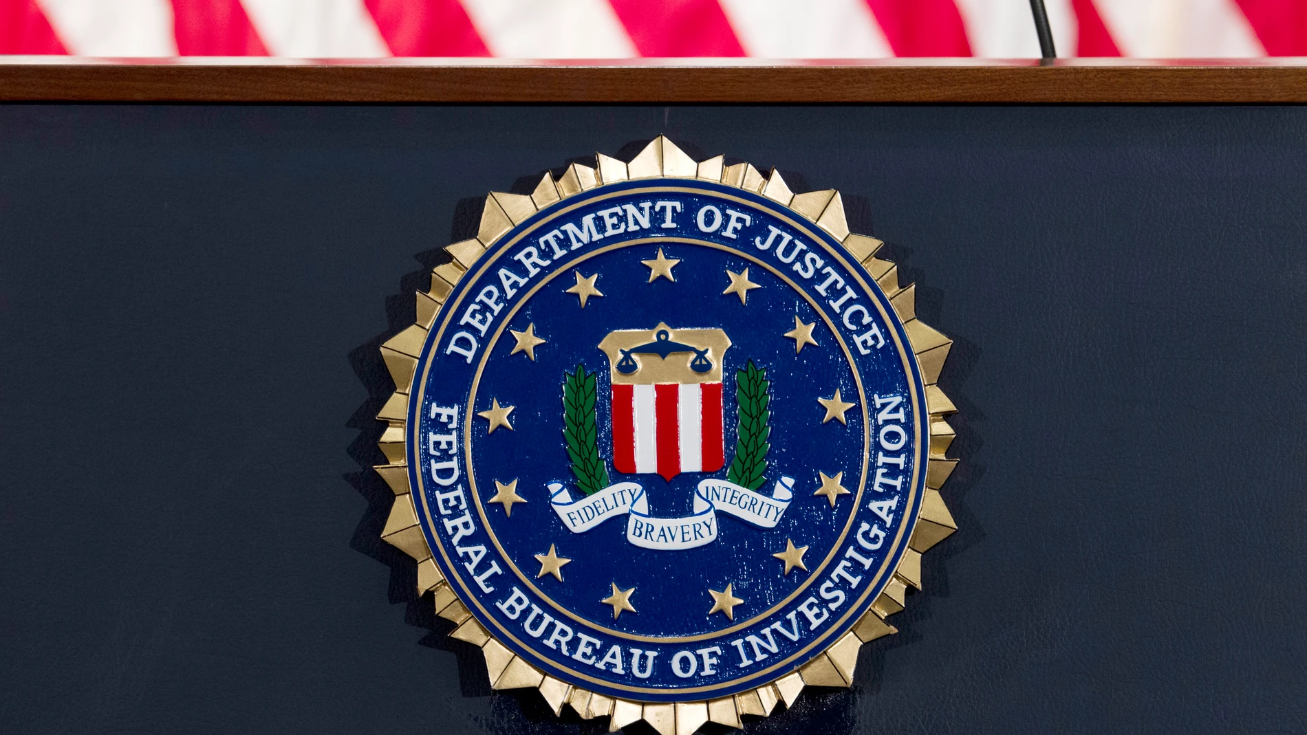 FILE - This June 14, 2018 file photo shows an FBI seal on a podium before a news conference at the agency's headquarters in Washington. (AP Photo/Jose Luis Magana, File)