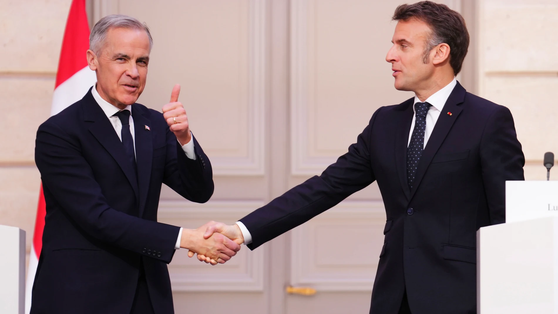 Canada Prime Minister Mark Carney, left, gives a thumbs up as he shakes hands with President of France Emmanuel Macron after delivering a joint statement at the Palais de l'Elysee in Paris, on Monday, March 17, 2025. (Sean Kilpatrick/The Canadian Press via AP)